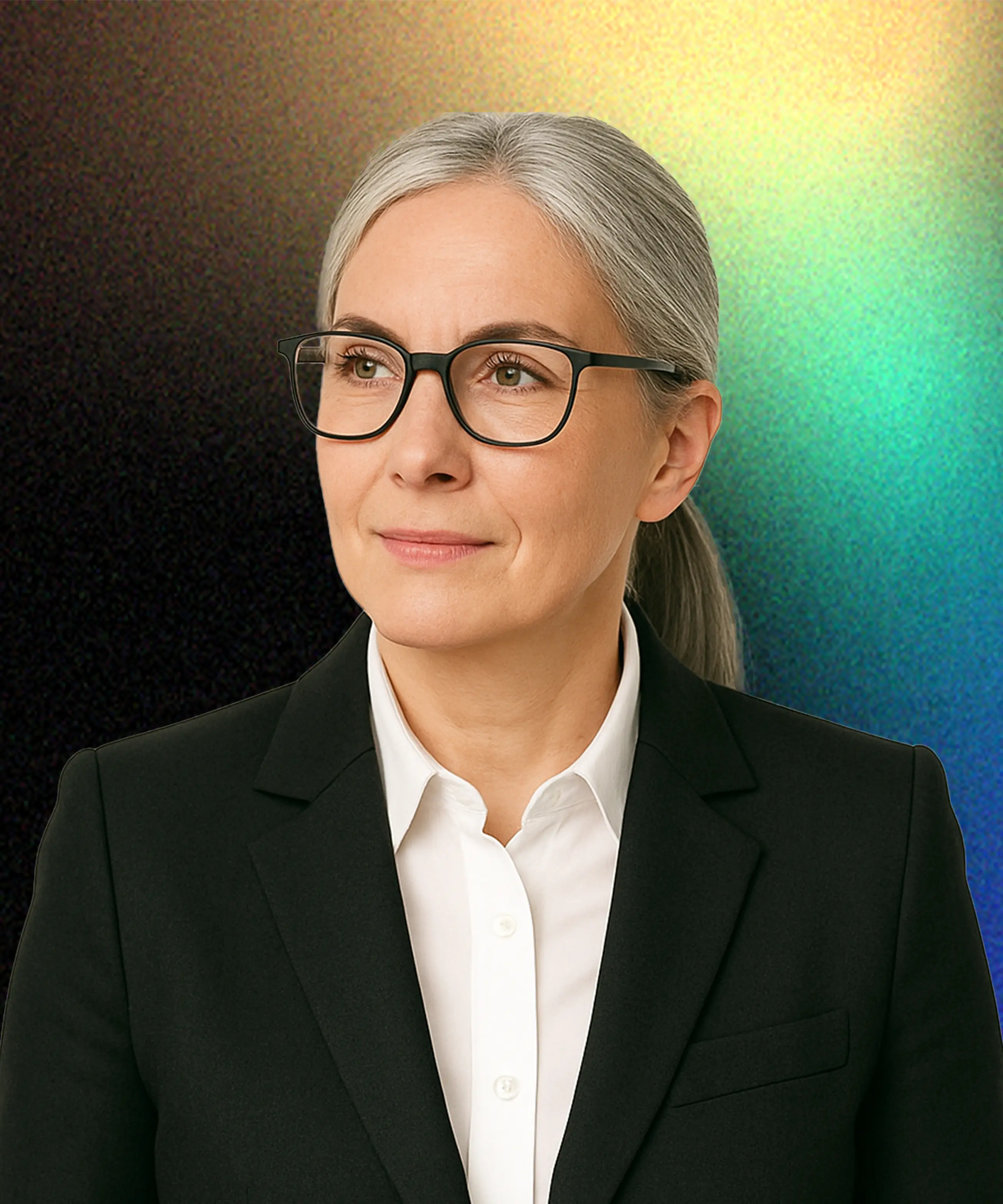 A woman wearing glasses and a black suit.