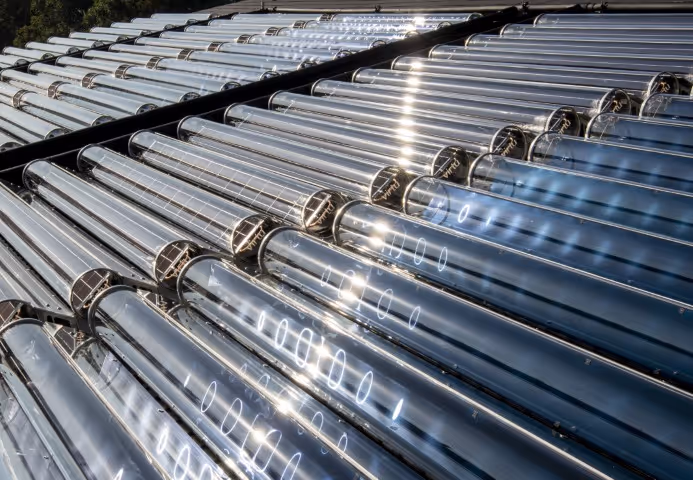 Sunlight reflecting off installed solar thermal collectors.