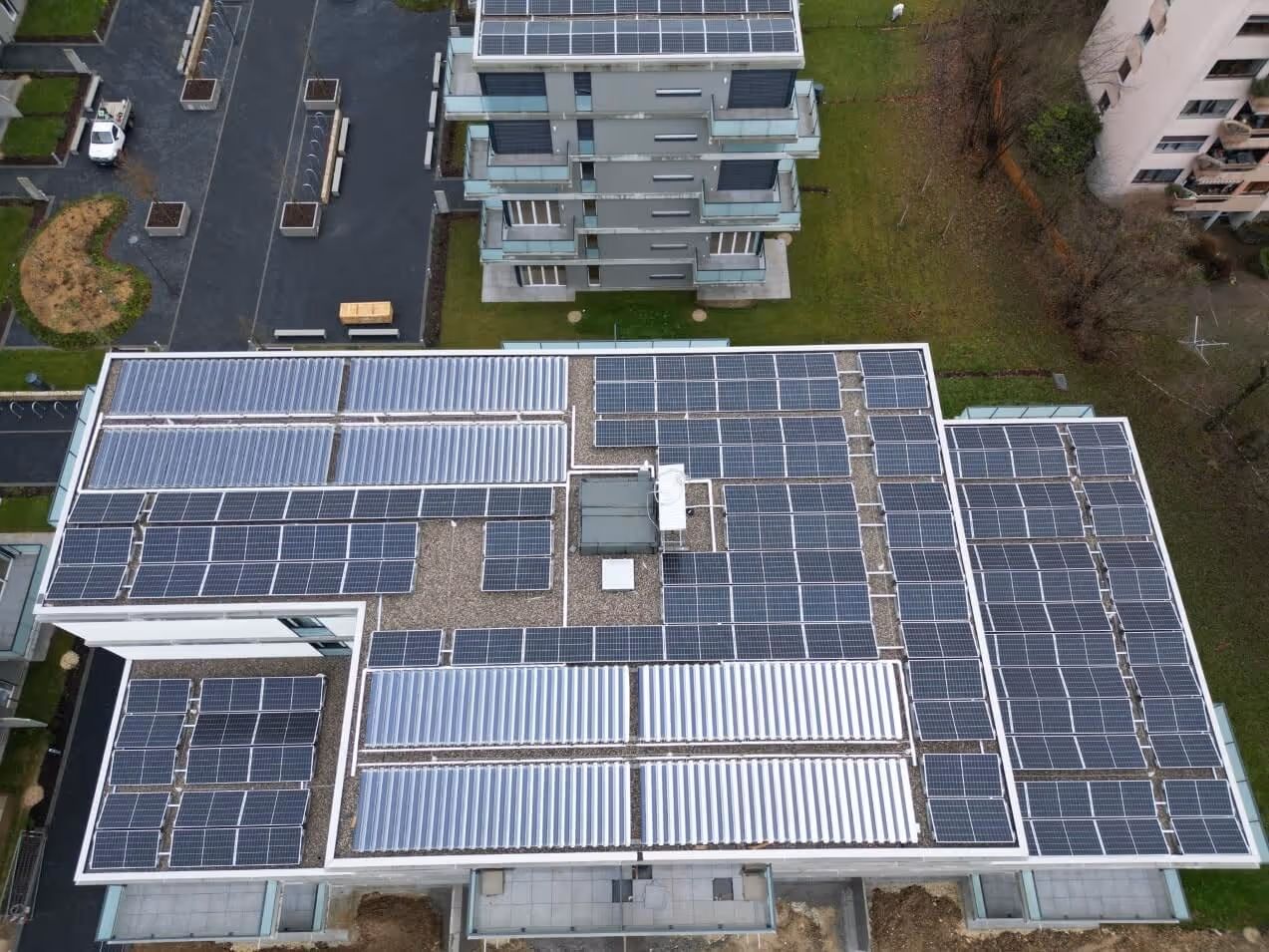 Arial shot of flat roof with solar thermal and solar PV panels on.