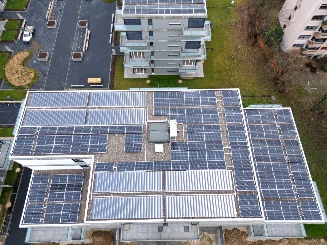 Arial shot of flat roof with solar thermal and solar PV panels.