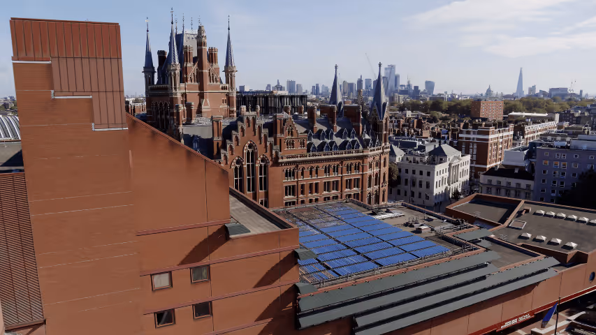 Ariel shot of British Library with solar thermal collectors on roof and London in background