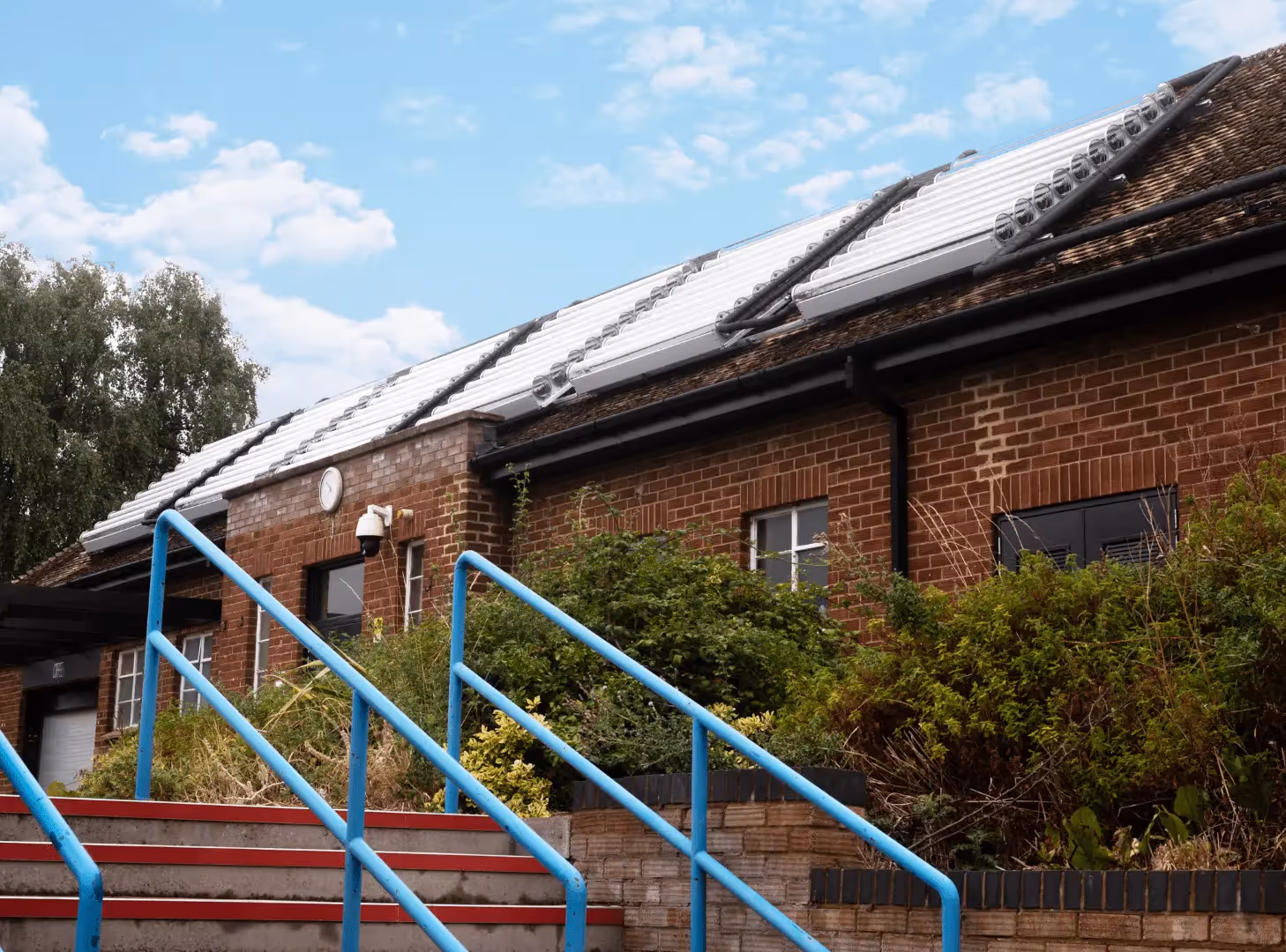 Bricked building with solar thermal panels on pitched roof.