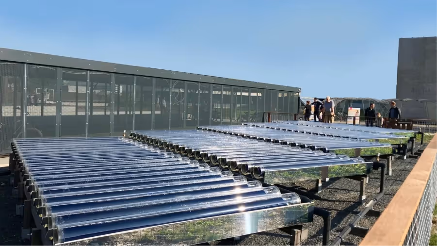 Rows of ground mount solar thermal collectors in front of building