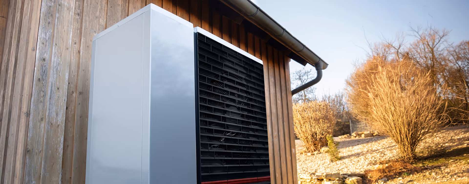 Heat pump next to wooden building
