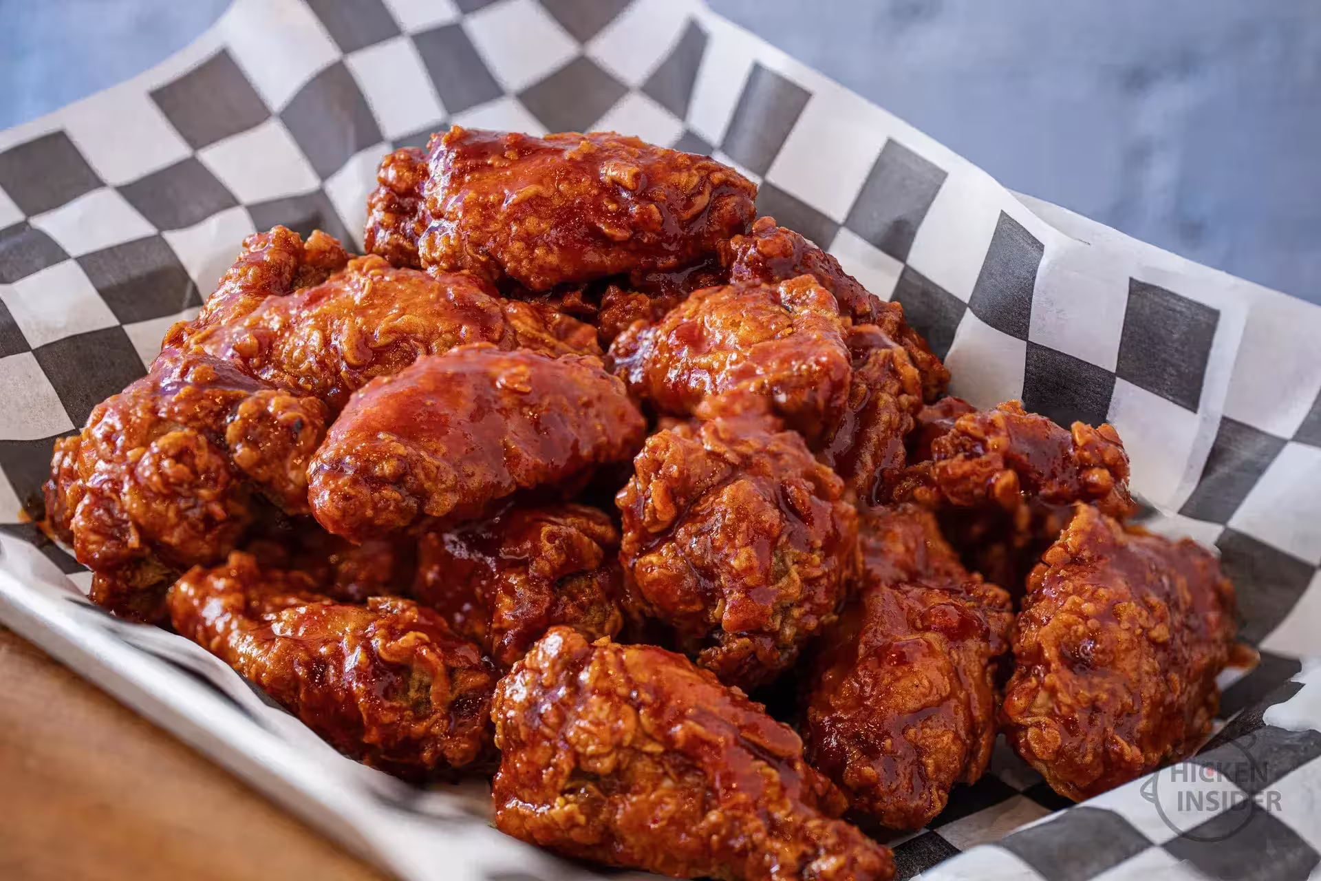 A closeup picture of Korean Fried Chicken tossed in Korean Sweet and Spicy Sauce. Chicken Insider serves authentic Korean Fried Chicken in Yorkville, New York City.