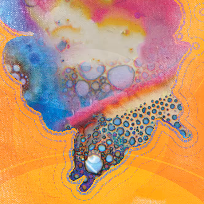 Close-up of colorful oil droplets suspended in water with orange, pink, blue, and purple hues and textured circular patterns.