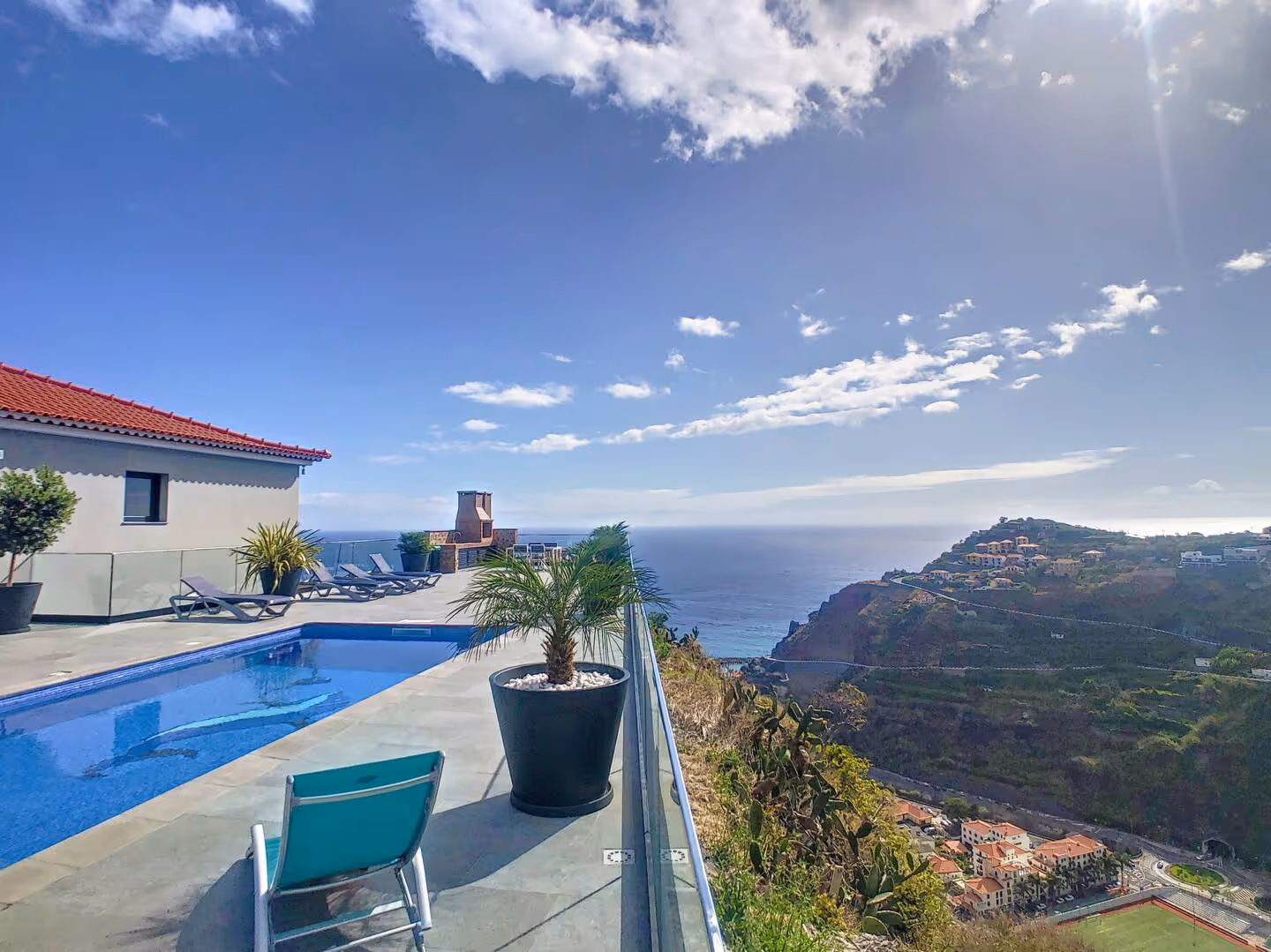 Outdoor pool and terrace with ocean and mountain views in Madeira, part of an Island Escape property.