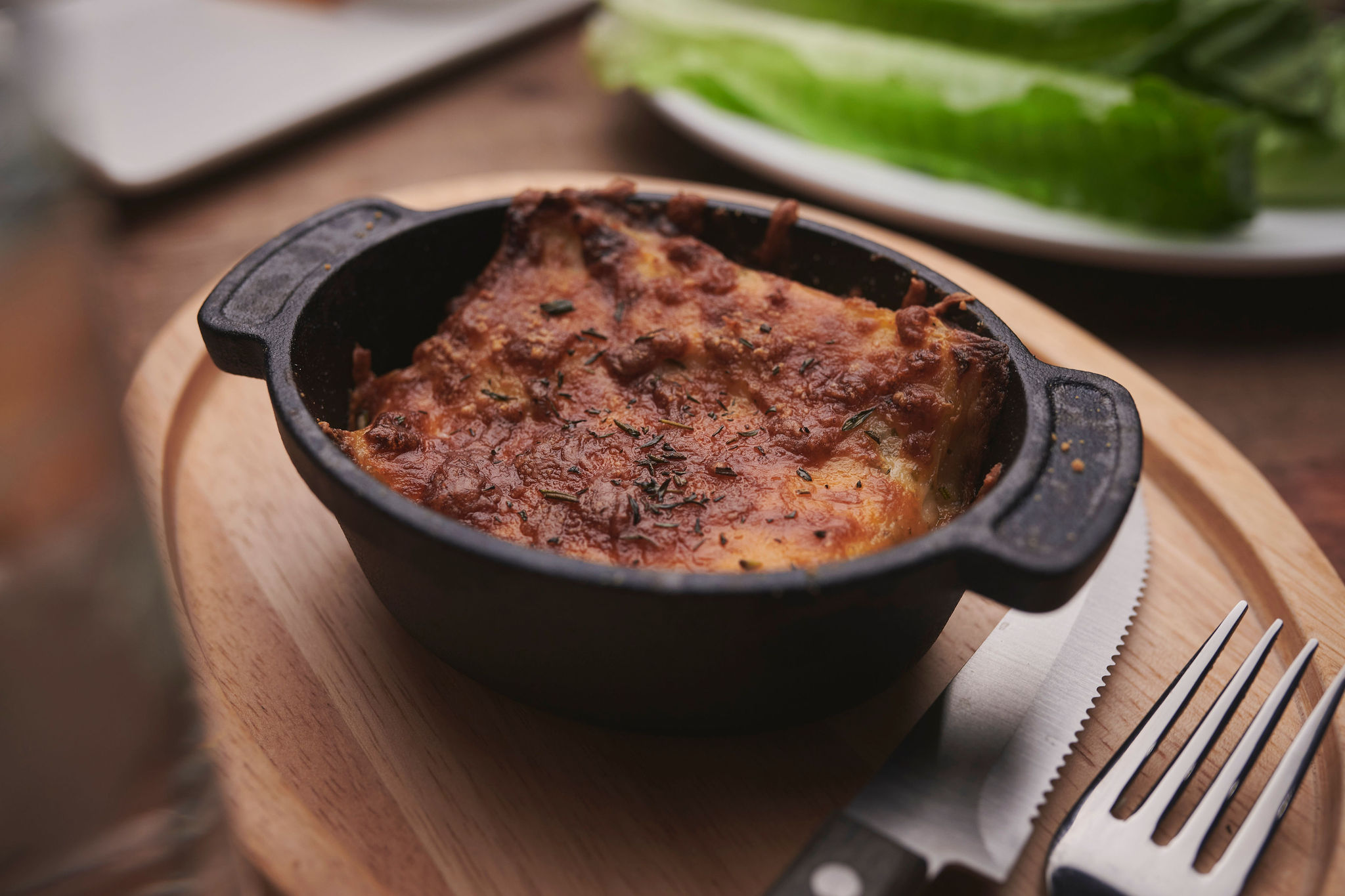 An oval cast iron dish with The Rock version of scallped potatoes.
