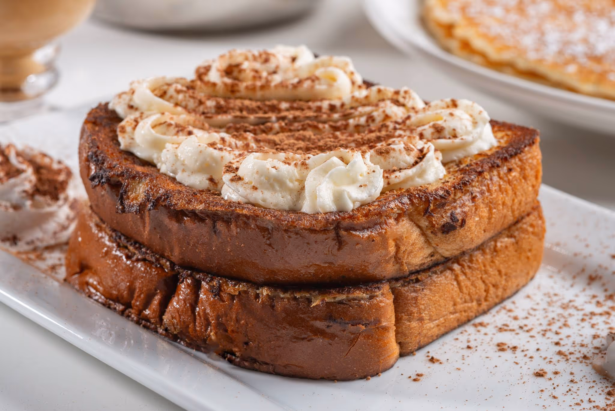 A piece of toast with whipped cream on top.