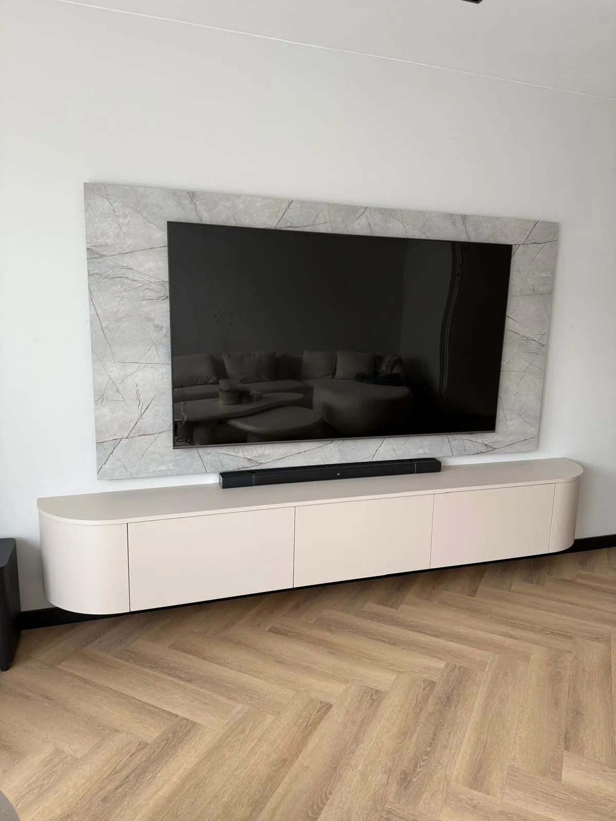 Modern tv-meubel in beige kleur met televisie erop
