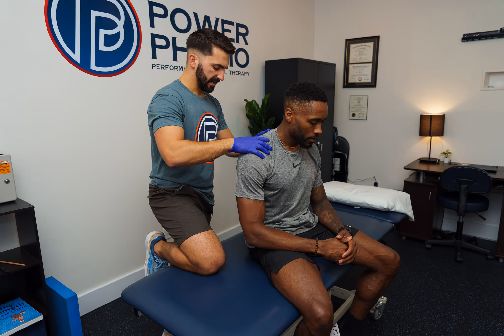 Physical therapist assessing shoulder strength in Charlotte PT clinic