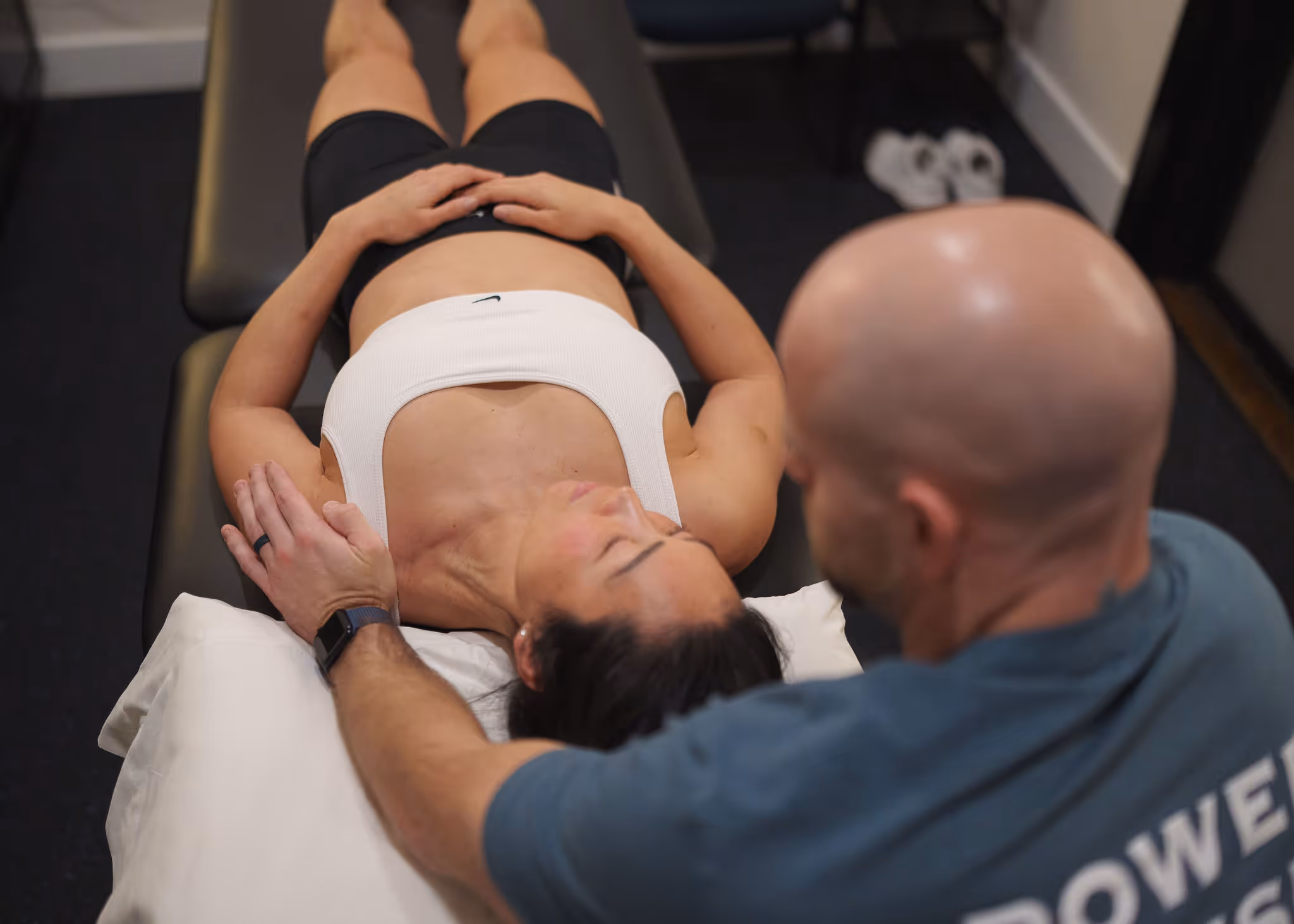 Physical therapist assessing shoulder strength in Charlotte PT clinic
