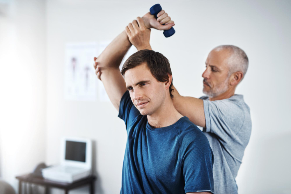 Board-certified physical therapist providing one-on-one elbow pain treatment to athlete in Charlotte PowerPhysio clinic