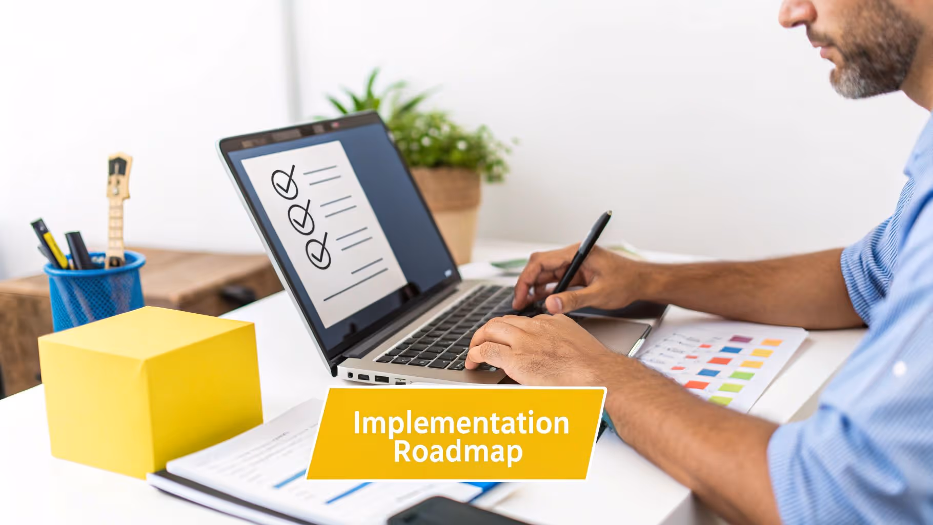 A person works on a laptop showing a checklist, with "Implementation Roadmap" banner.