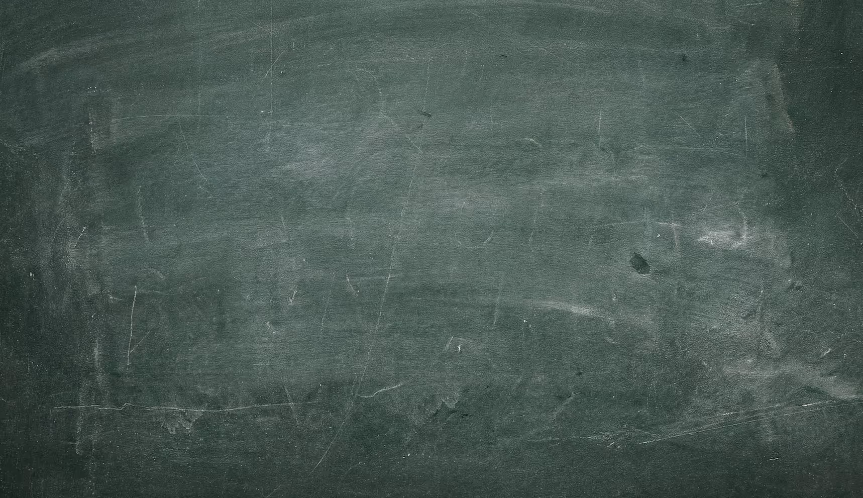 Close-up of a blank, worn green chalkboard with visible scratches and chalk smudges.