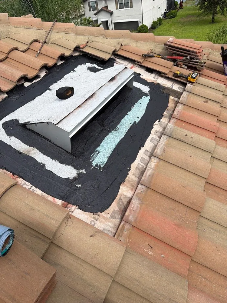 New roof vent set on new underlayment and sealed before the tile goes back on