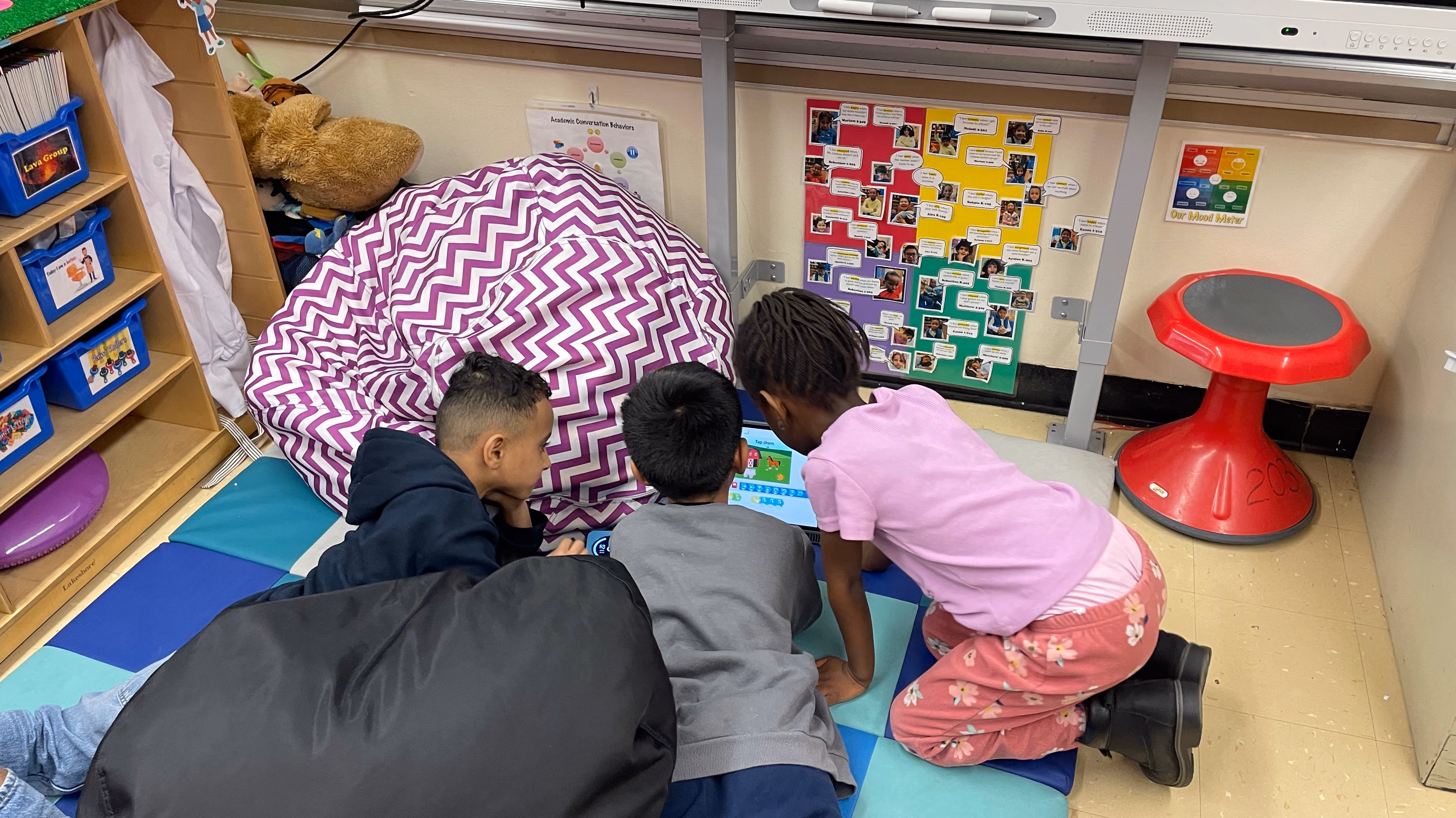 Three students reading together in classroom learning center
