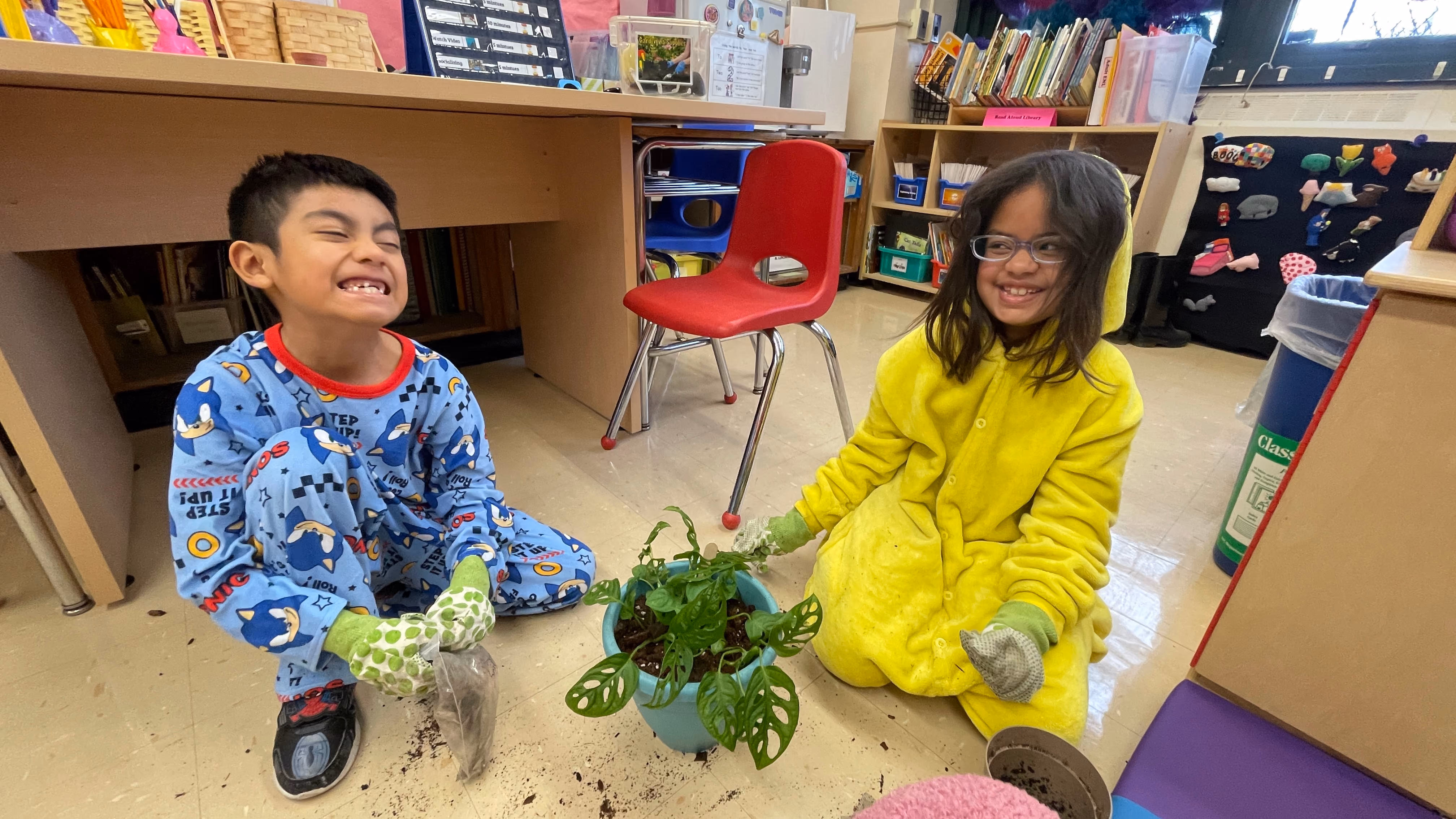 Two students planting and caring for classroom plants
