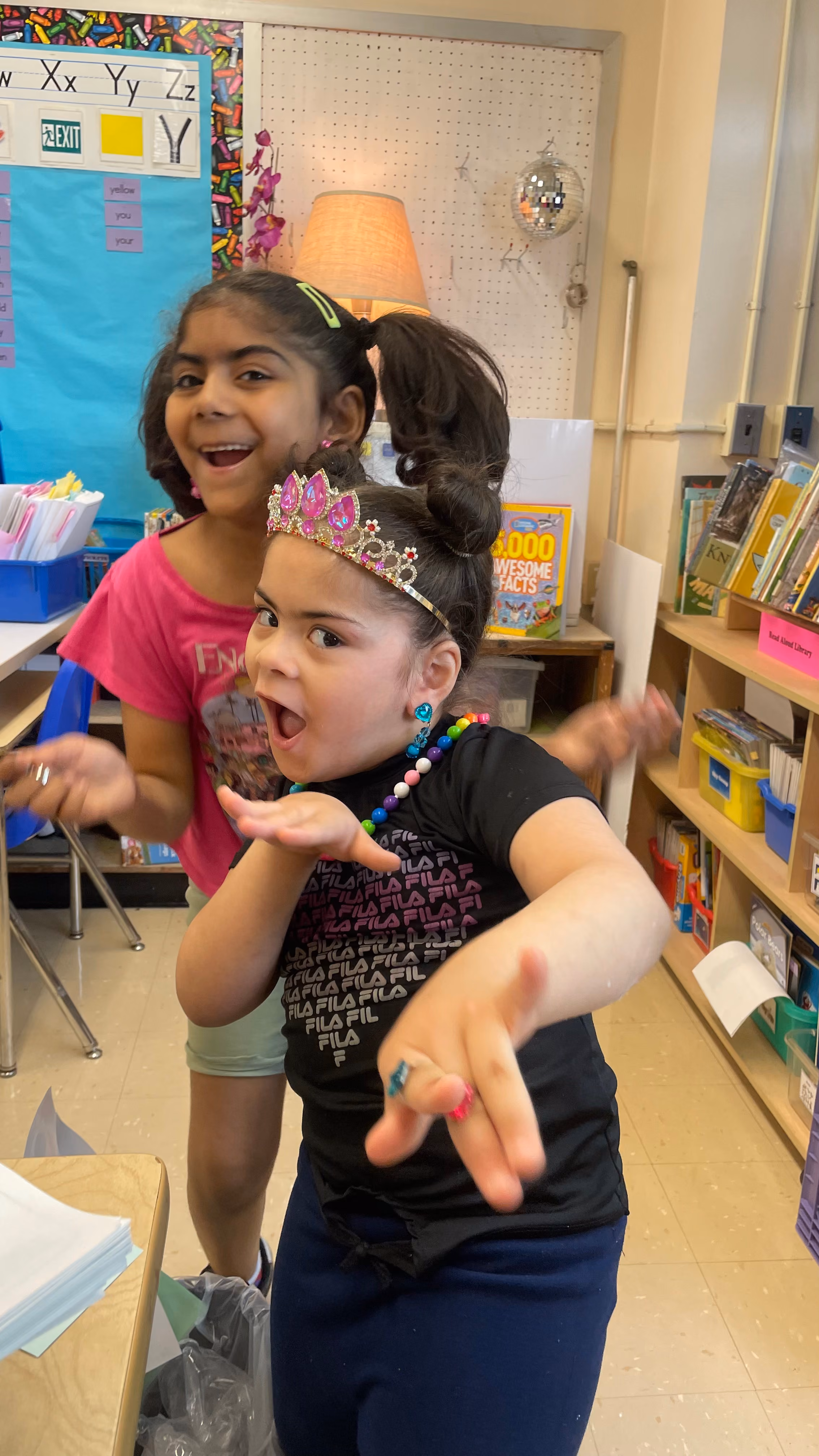 Two students celebrating and dancing in classroom