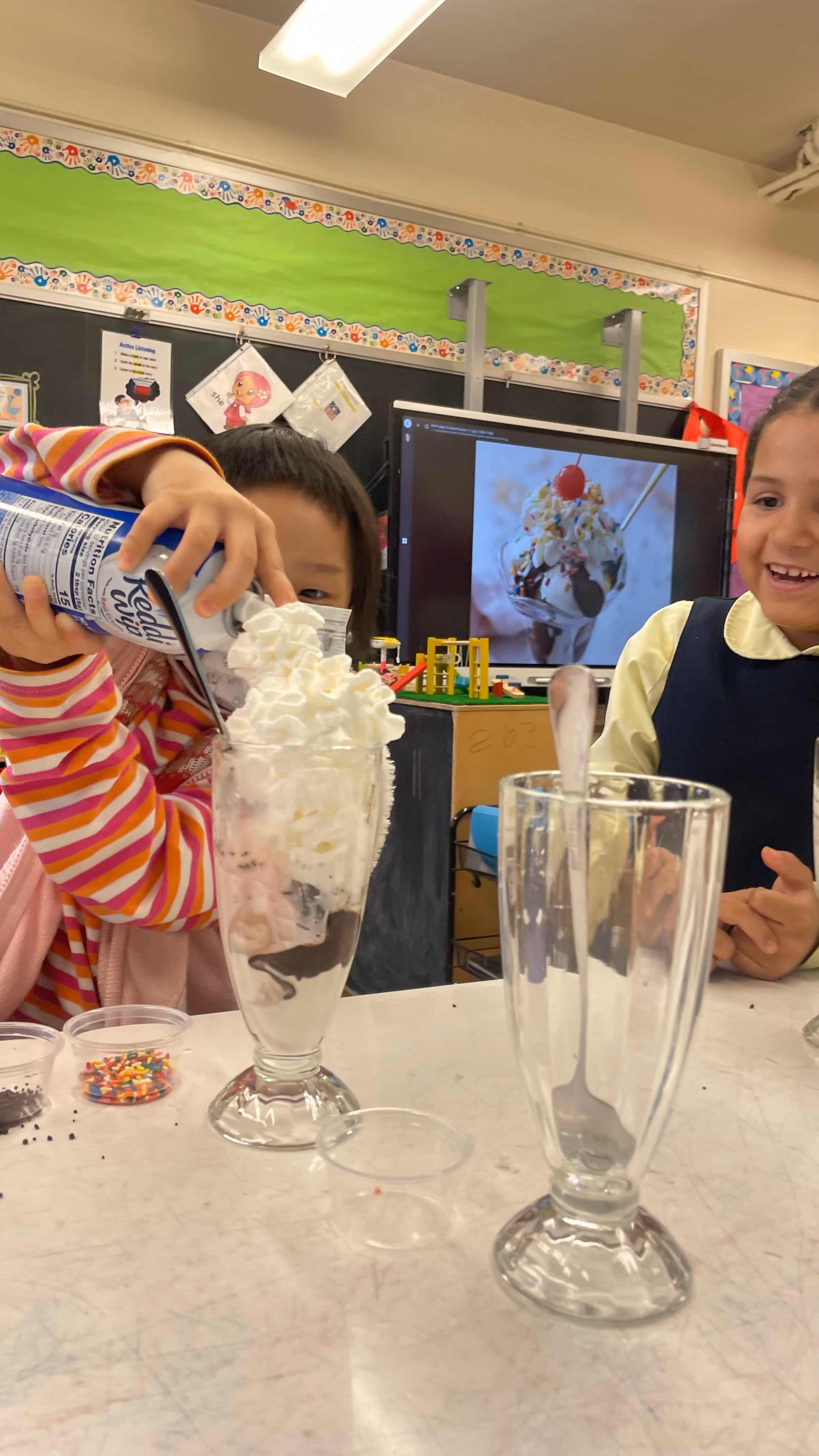 Students making ice cream sundaes in classroom activity