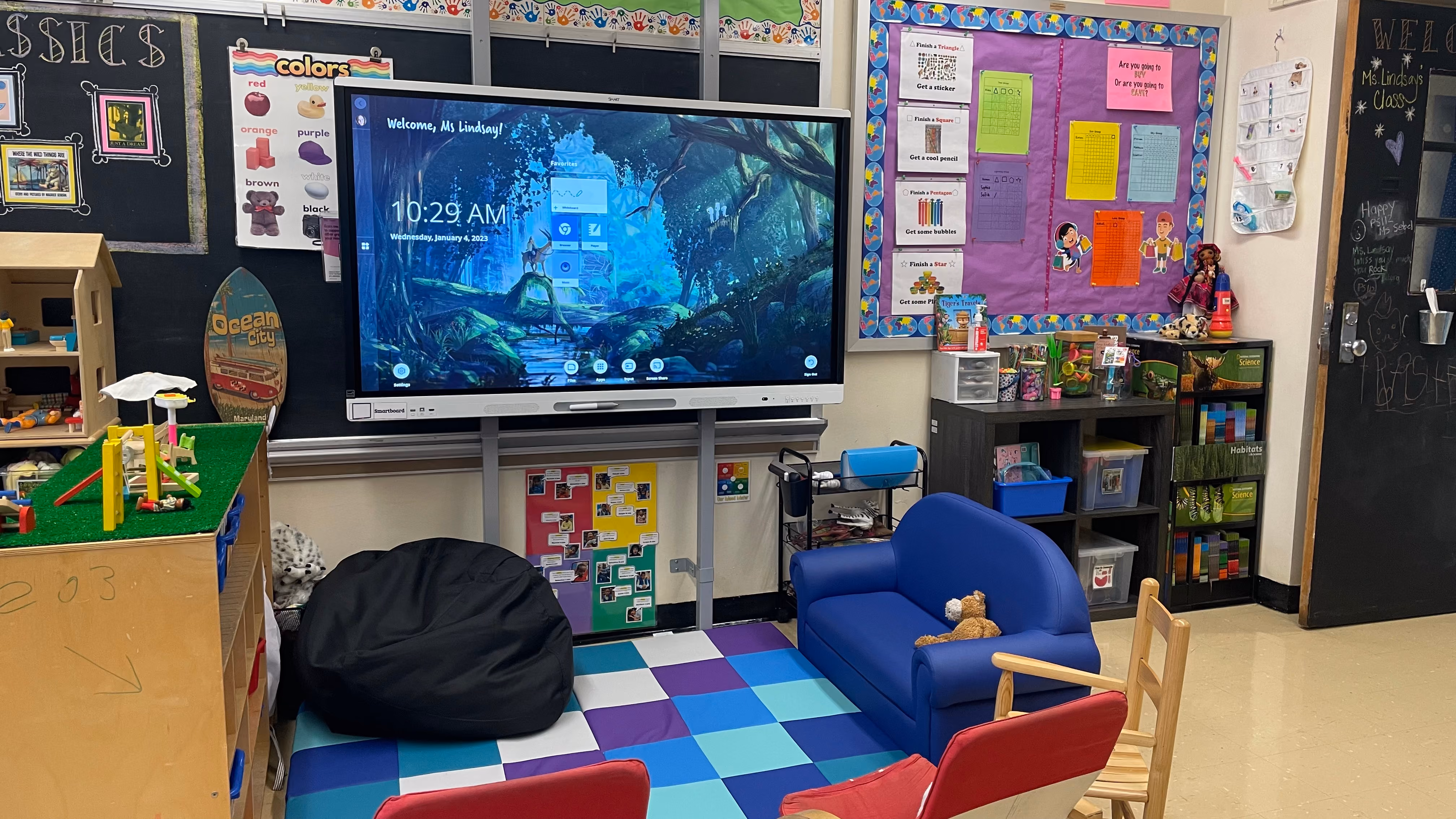 Elementary classroom reading area with interactive screen and colorful seating