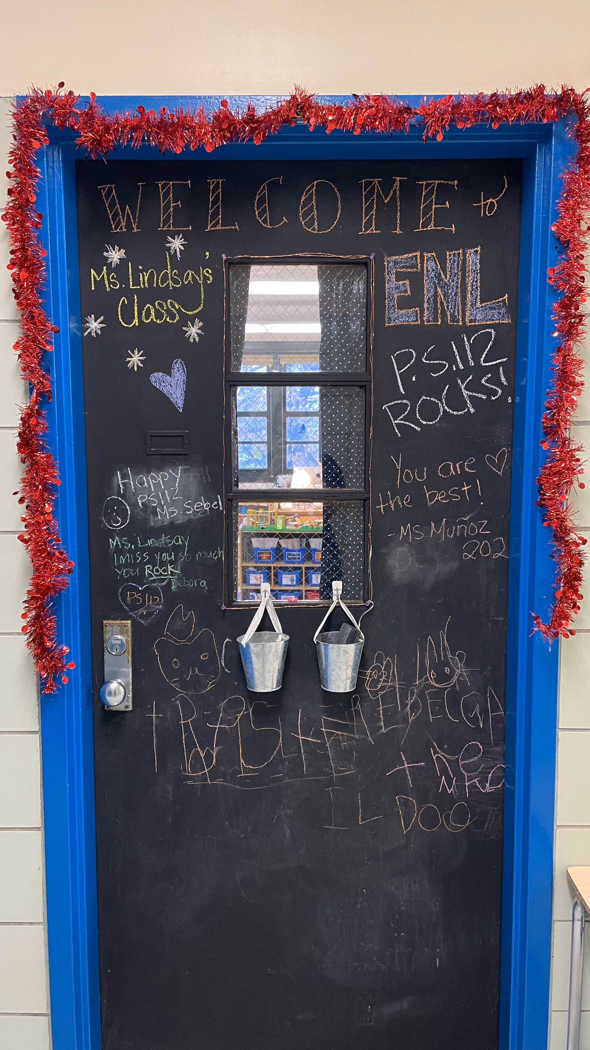 Classroom door decorated with welcome messages and student names
