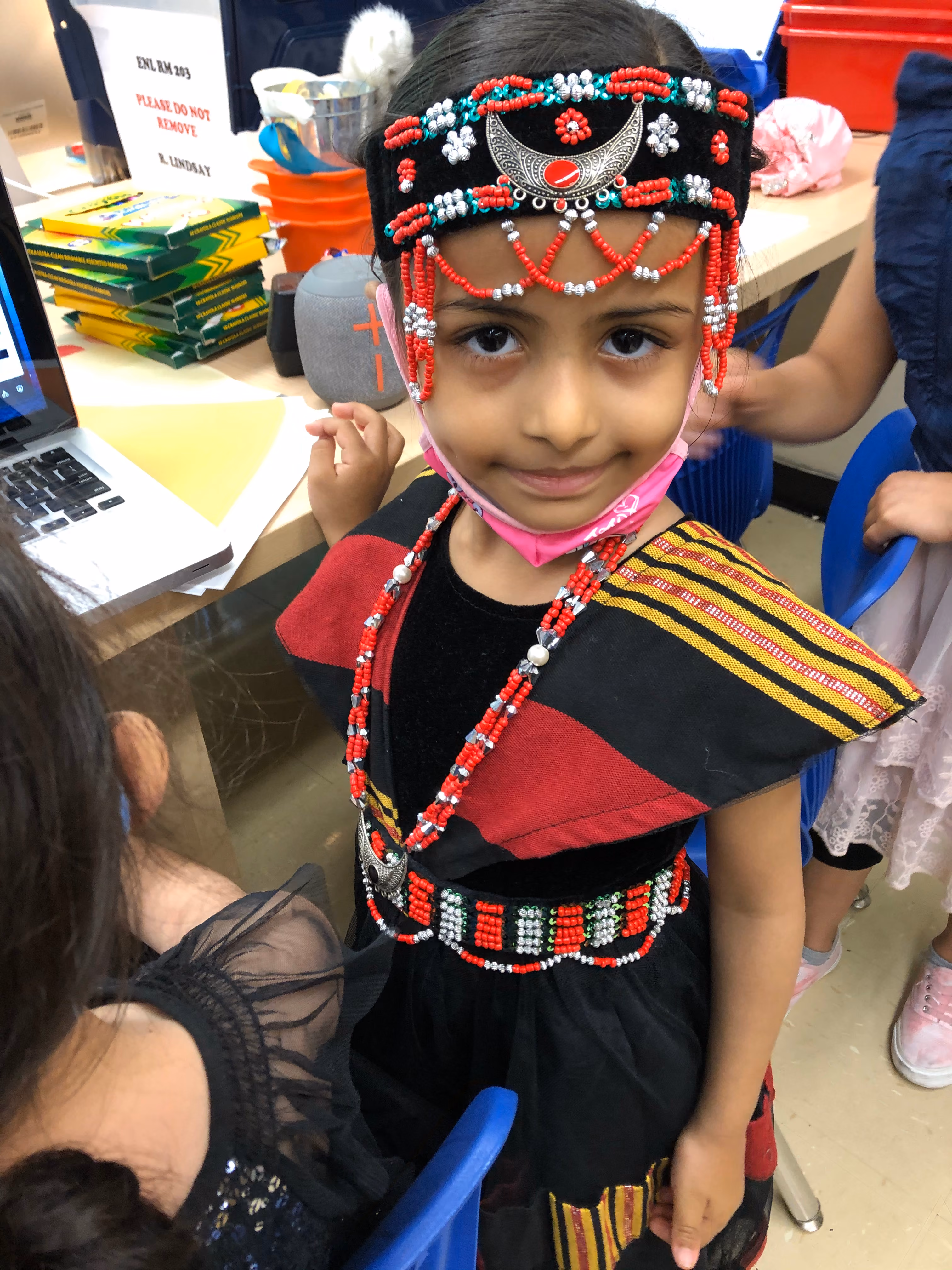 Student wearing traditional beaded headdress and costume