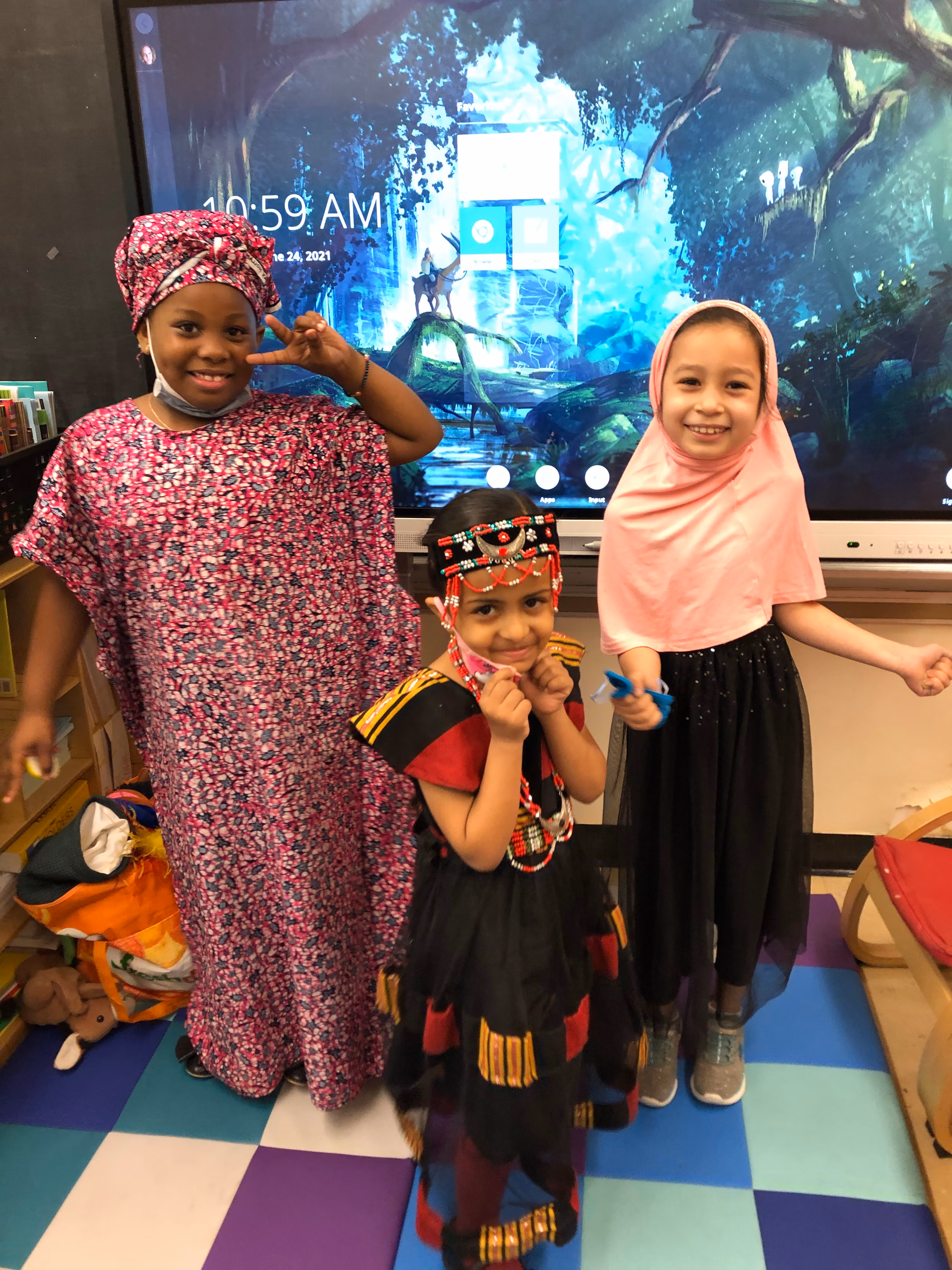Three students in traditional cultural clothing from different countries