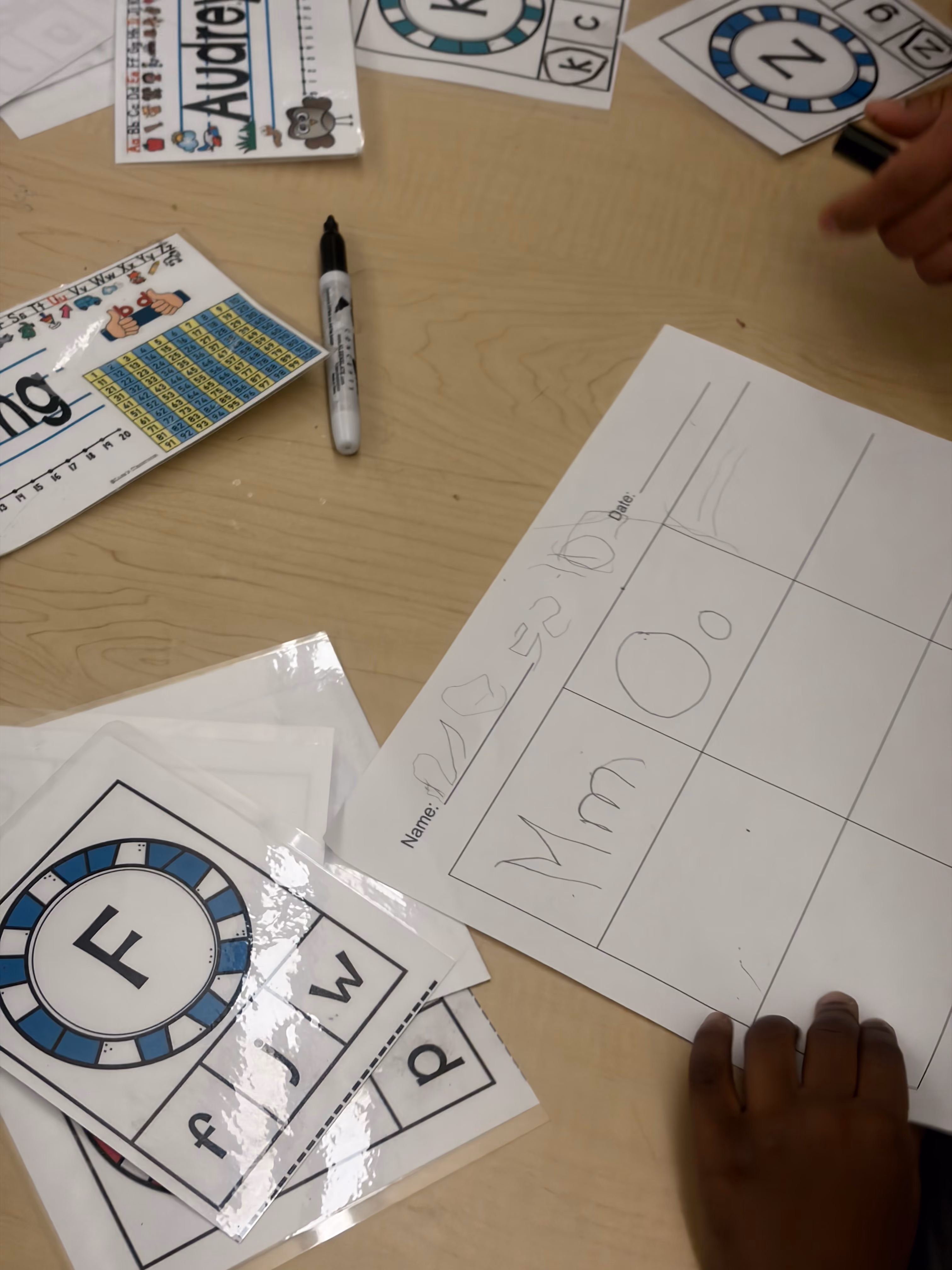 Students working with letter and number learning materials