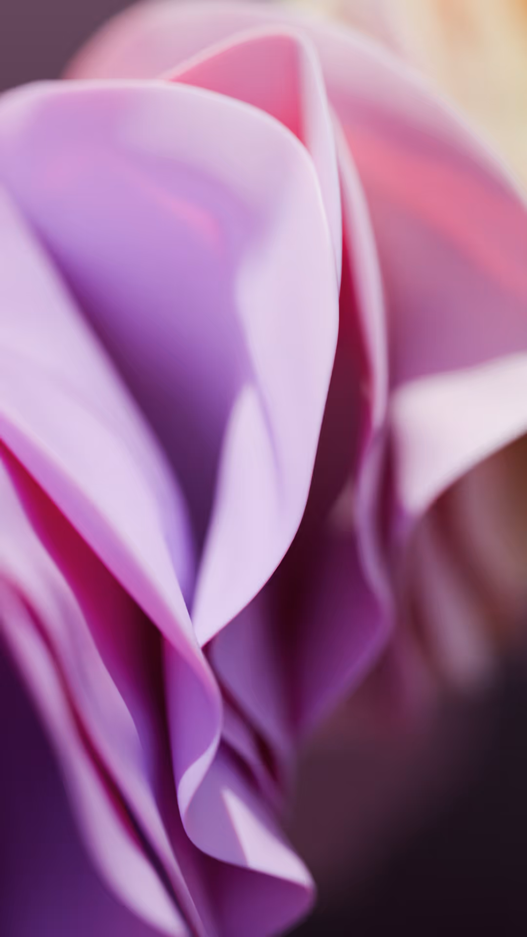Close-up of soft, flowing fabric folds in shades of purple and pink with smooth gradients.