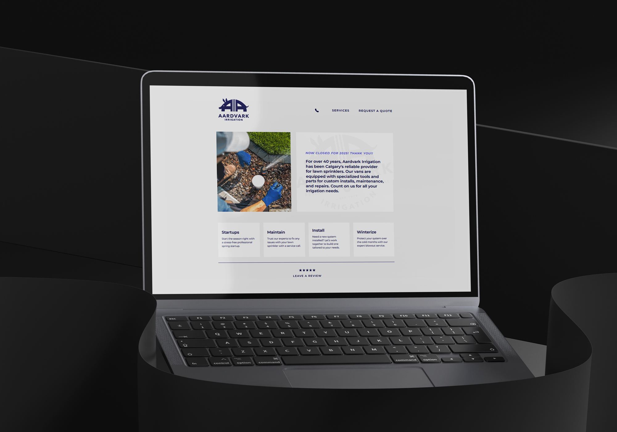 Open laptop displaying Aardvark Irrigation website with service descriptions and contact options.