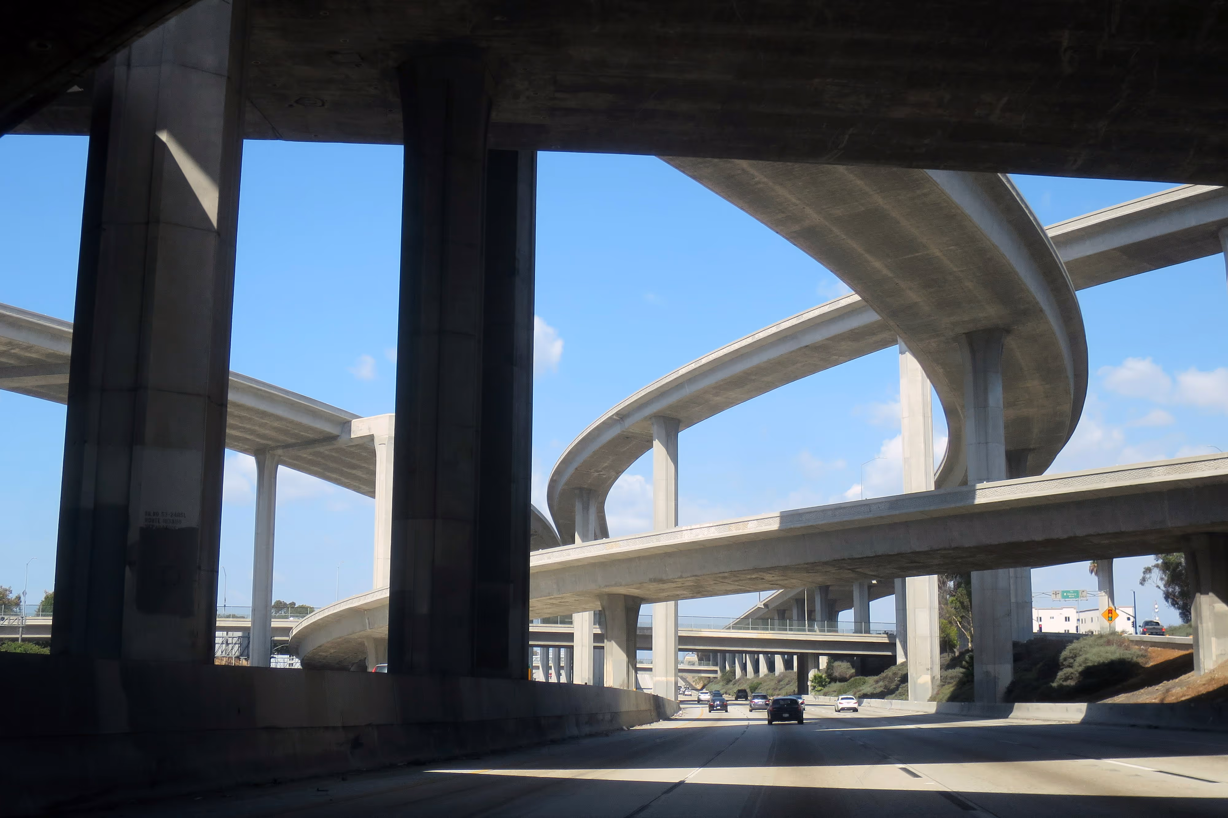 Multi-level concrete highway overpasses under clear sky.