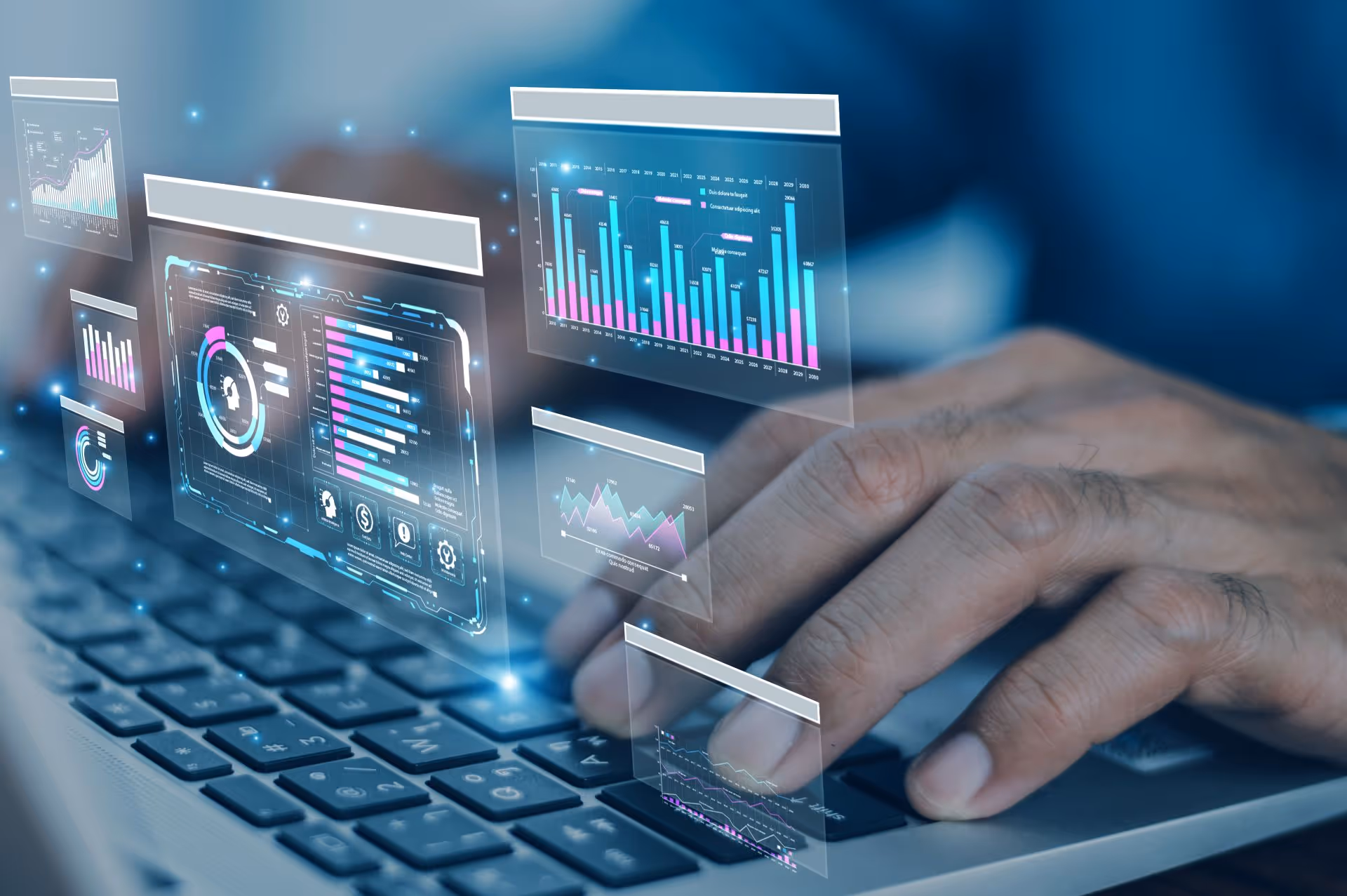 Close-up of hands typing on a laptop keyboard with floating futuristic data analytics and charts overlays.
