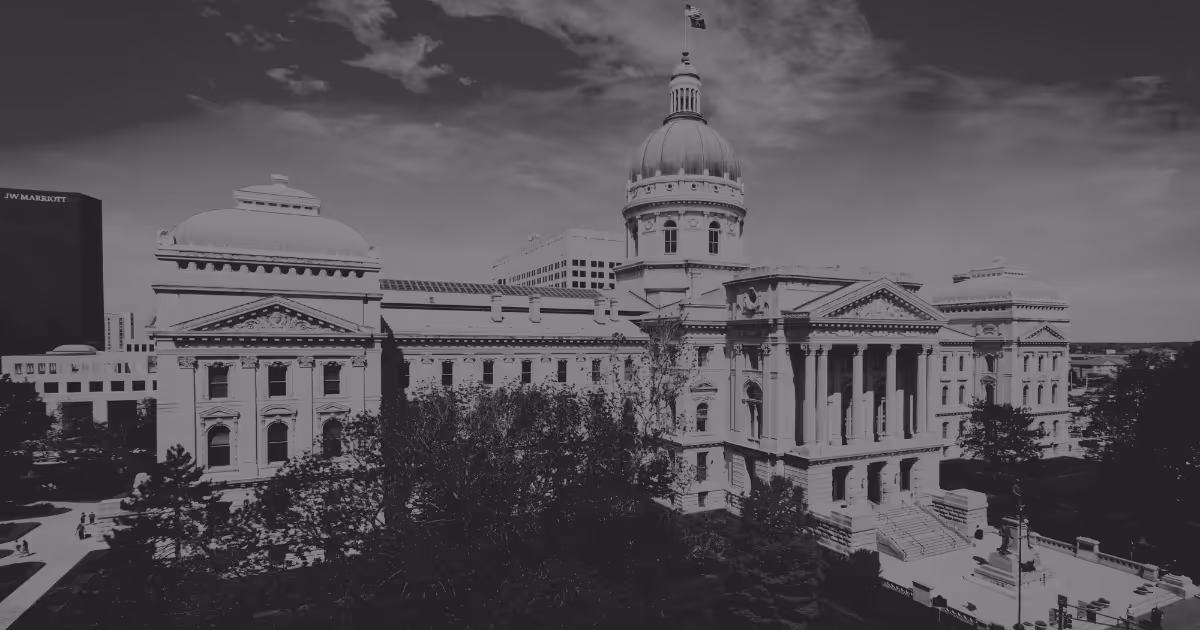 Indiana state capitol building under a partly cloudy sky.