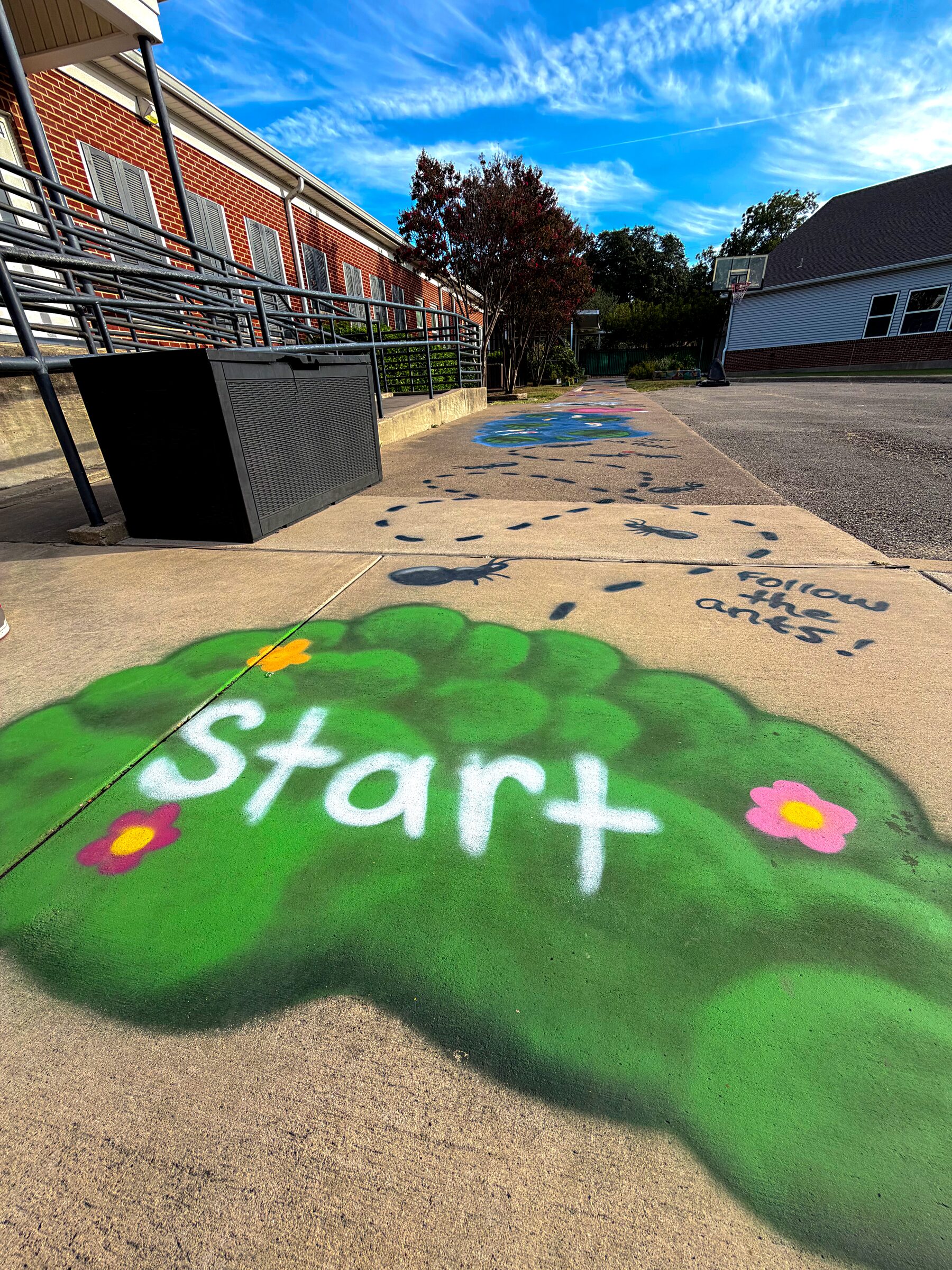 Aerial view of a hearts-and-ravens themed sidewalk obstacle course at Rapoport Elementary.