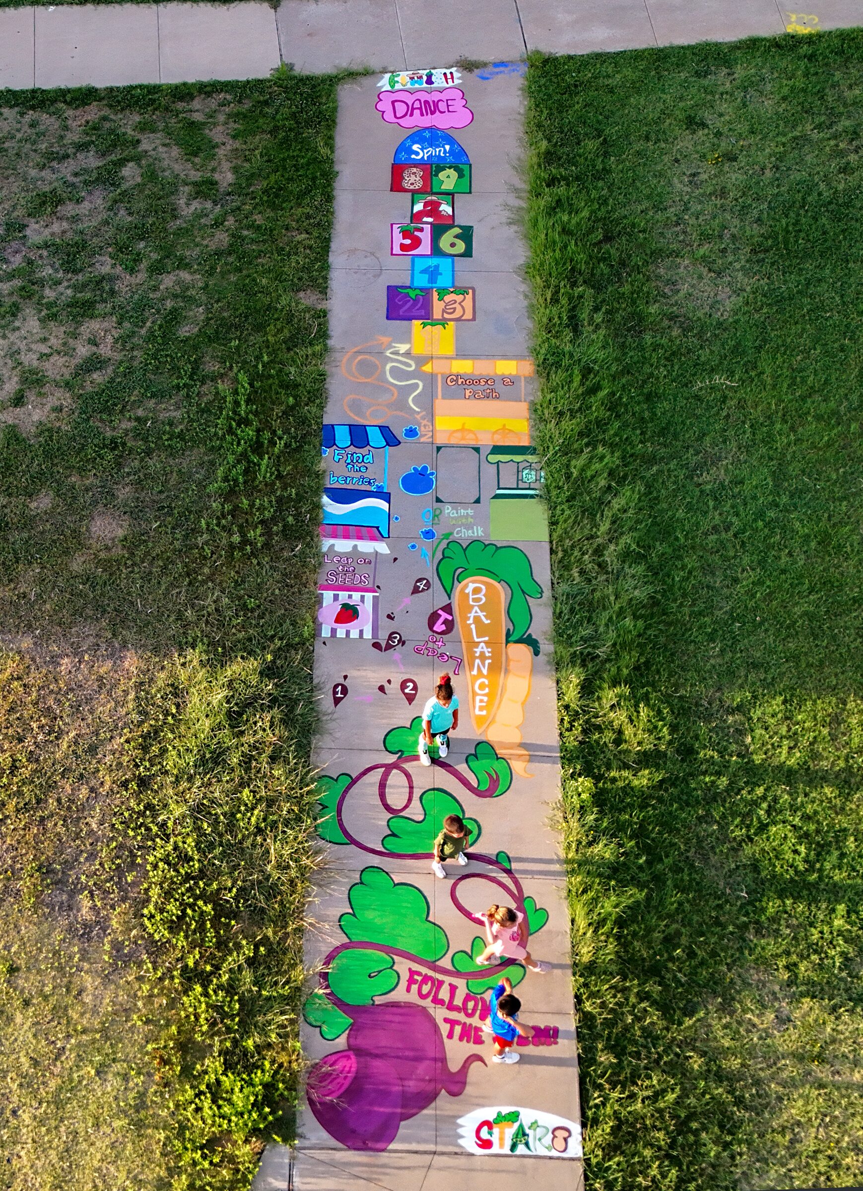 Aerial view of a farmers-market-themed sidewalk obstacle course at Doris Miller Community Center.