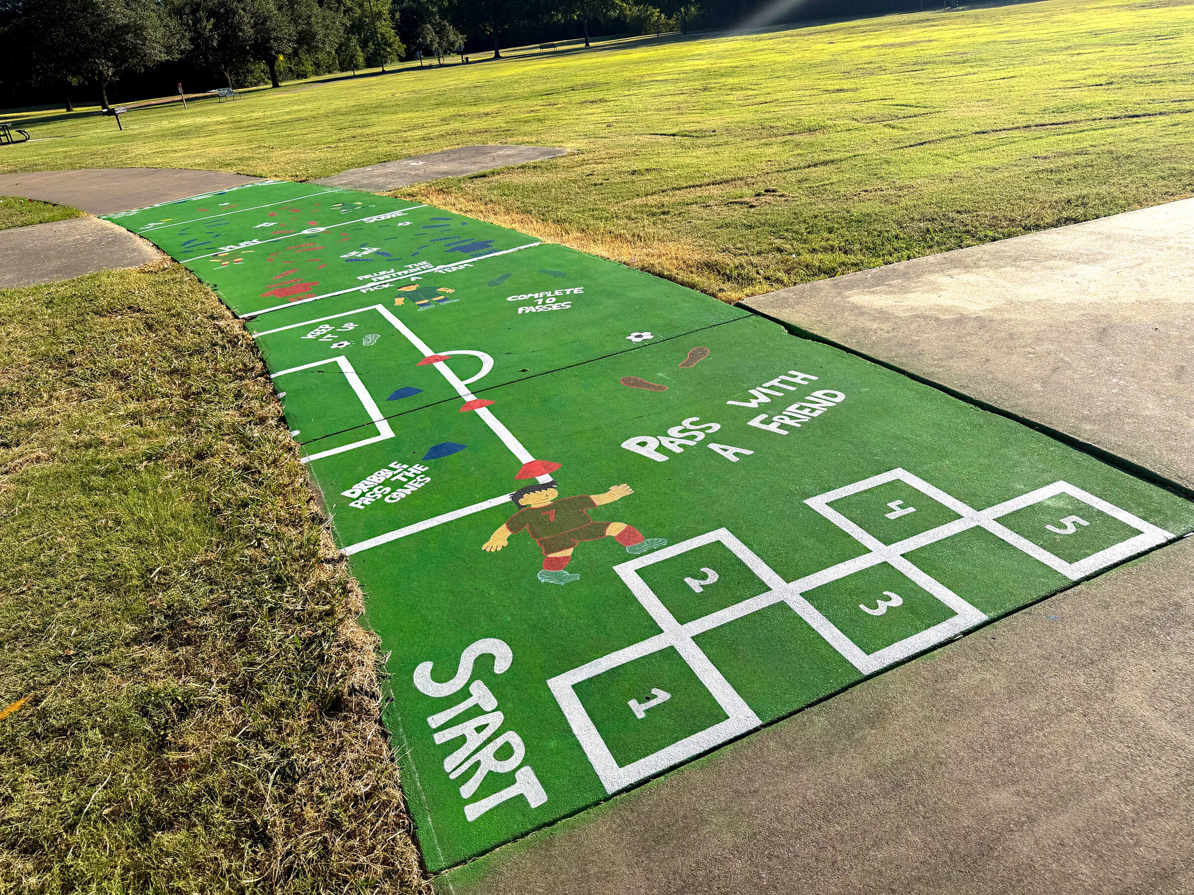 Aerial view of a soccer-themed sidewalk obstacle course at Edna Park in North Waco.