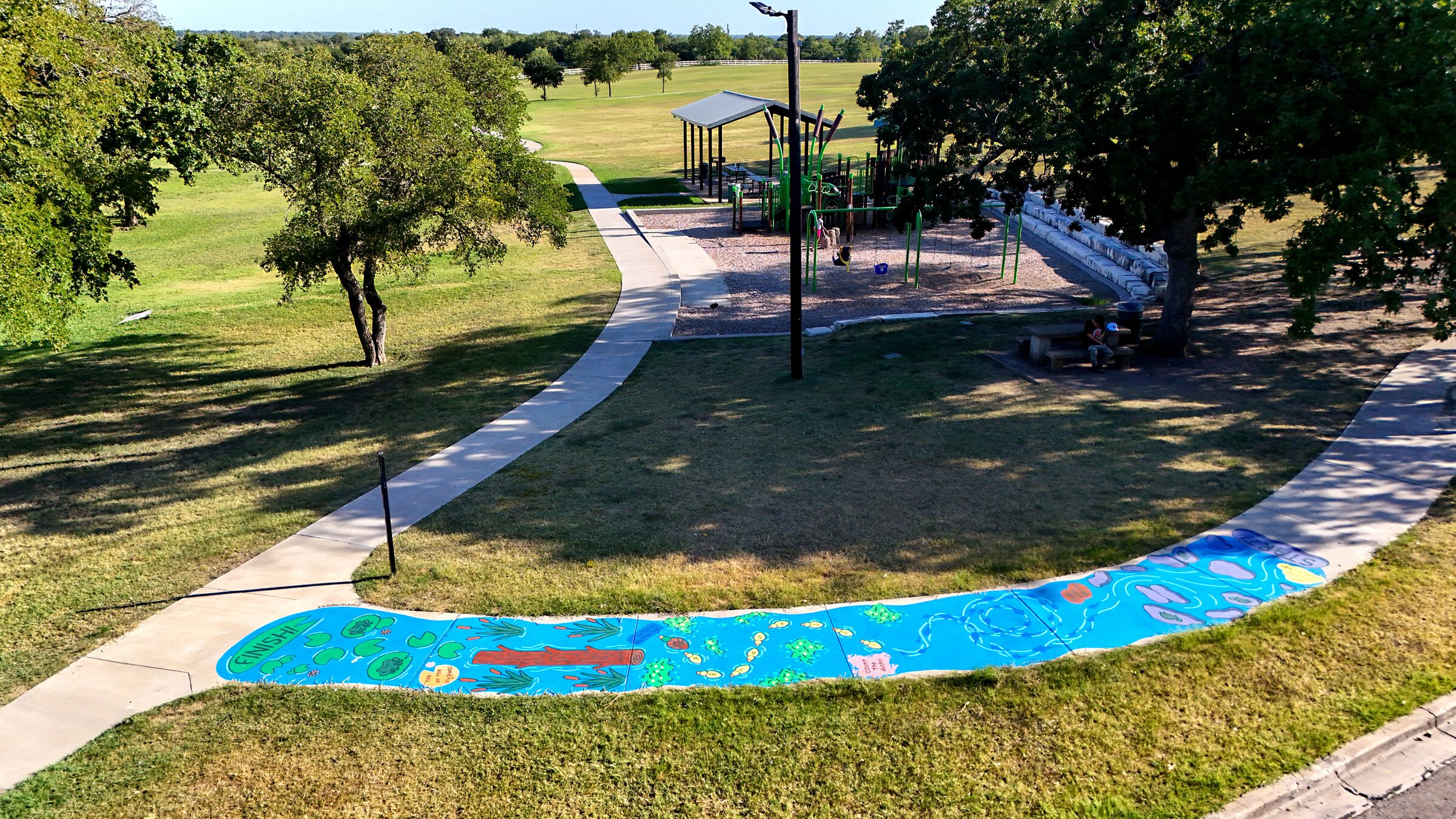Aerial view of a swamp-river-themed sidewalk obstacle course at Buena Vista Park.