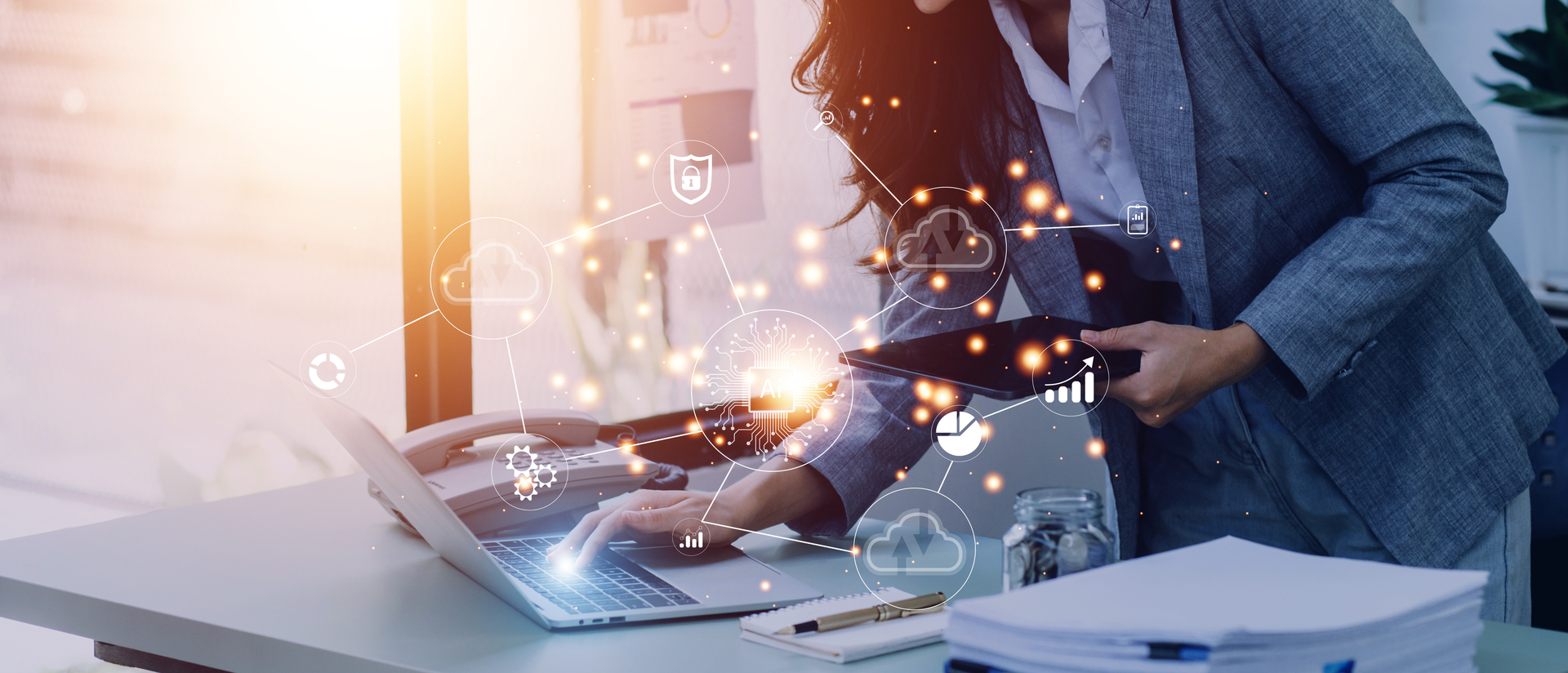 Office team collaborating at a desk while using AI tools on a laptop to review business performance