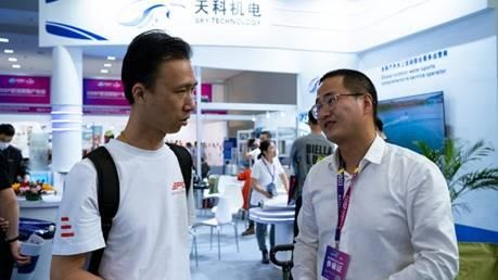 A group of men talking in a roomAI-generated content may be incorrect.