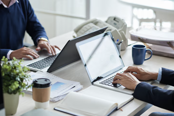 A group of people using laptopsAI-generated content may be incorrect.