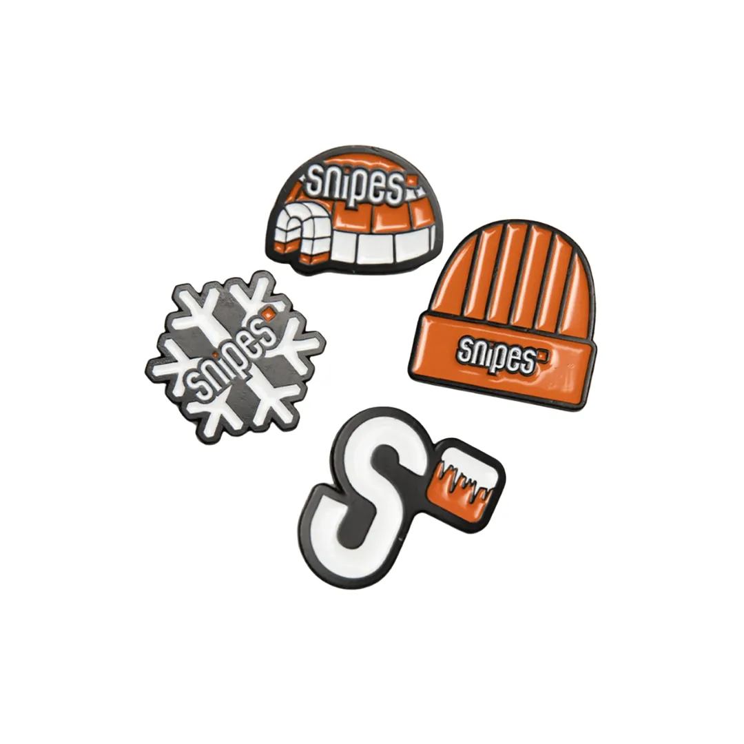 Four custom enamel pins made with winter theme and orange and white enamel