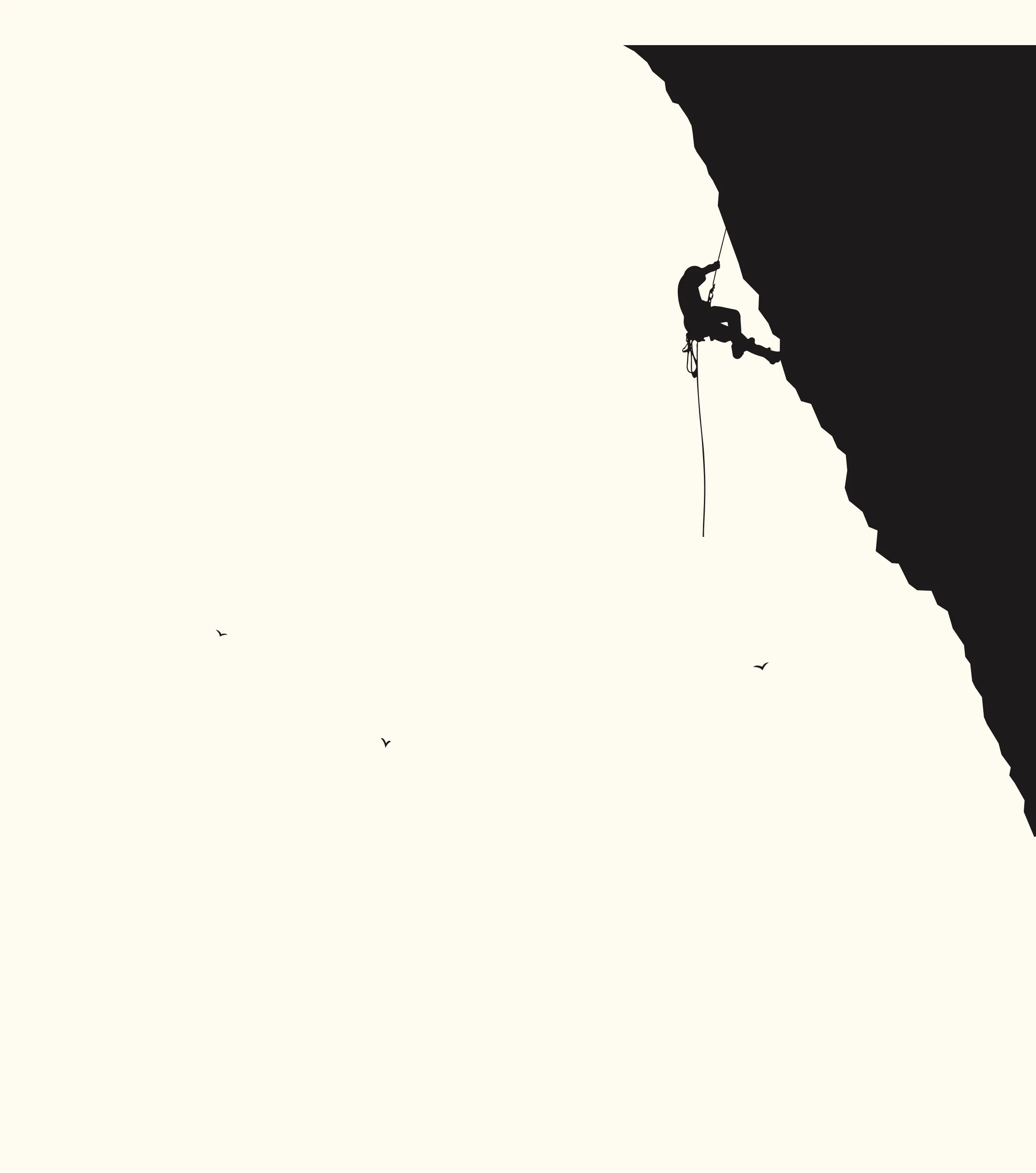 Silhouette of a climber scaling a dark cliff face