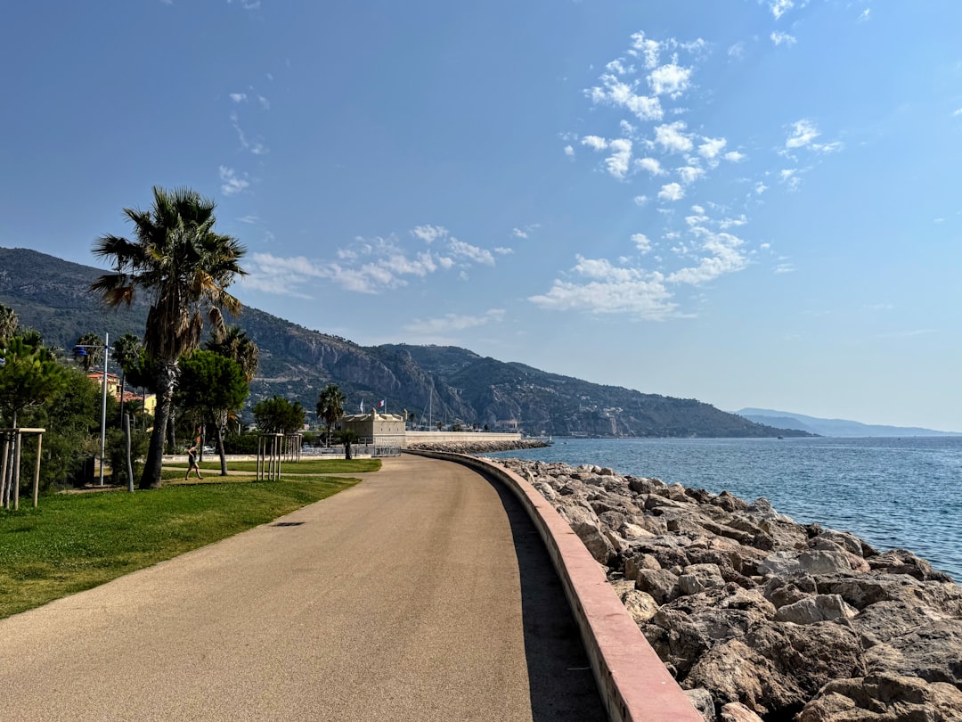 Coastal road next to the sea with mountains.