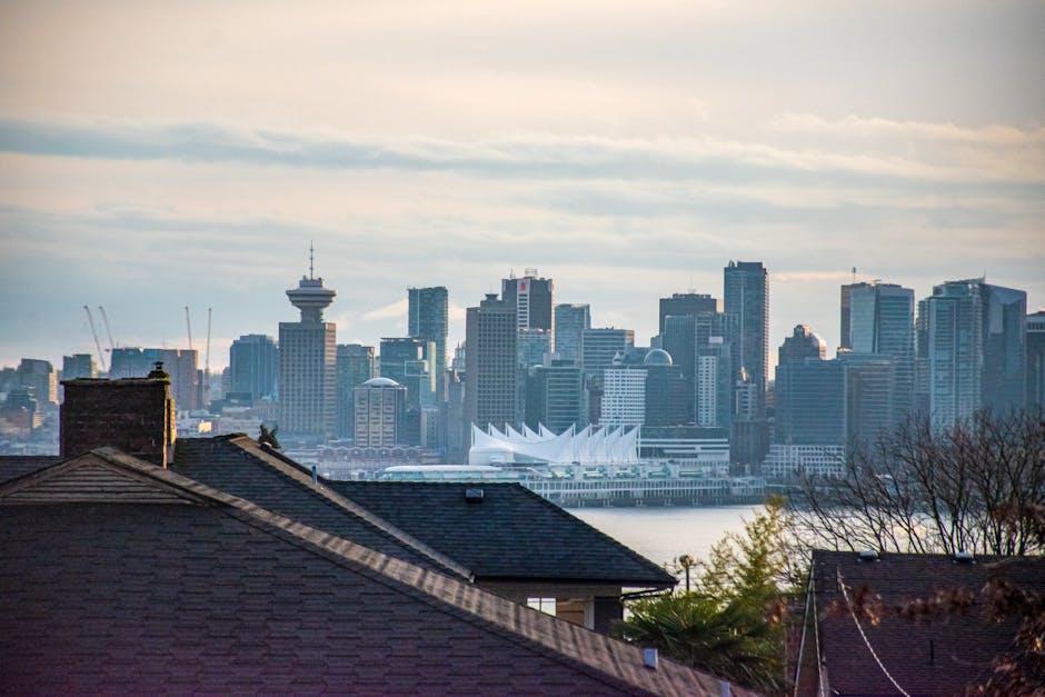 Vancouver cityscape showcasing the iconic skyline and Canada Place against a cloudy sky.