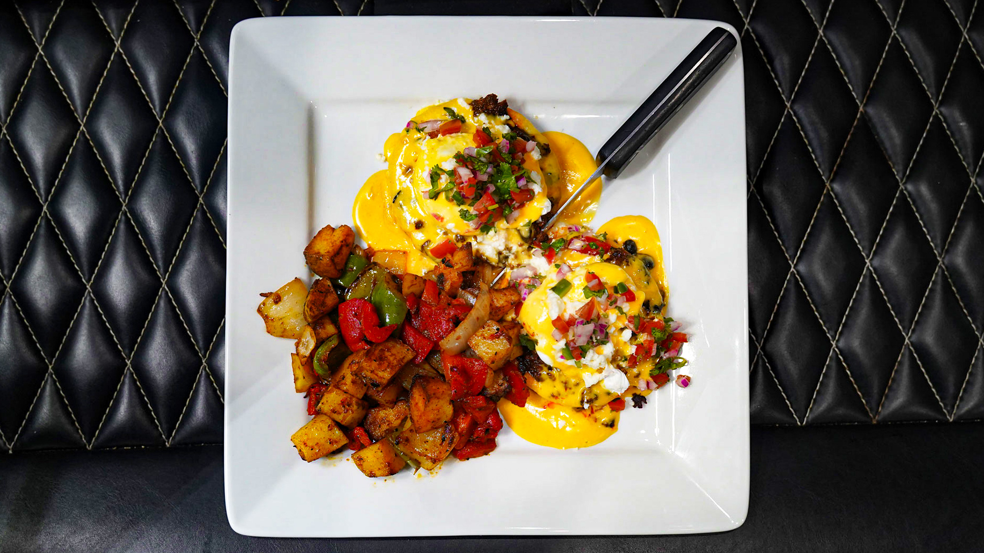 Chorizo, black beans & poached eggs on crispy sopes shells topped with chipotle hollandaise, queso fresco and pico de gallo. Chorizo, black beans & poached eggs on crispy sopes shells topped with chipotle hollandaise, queso fresco and pico de gallo.