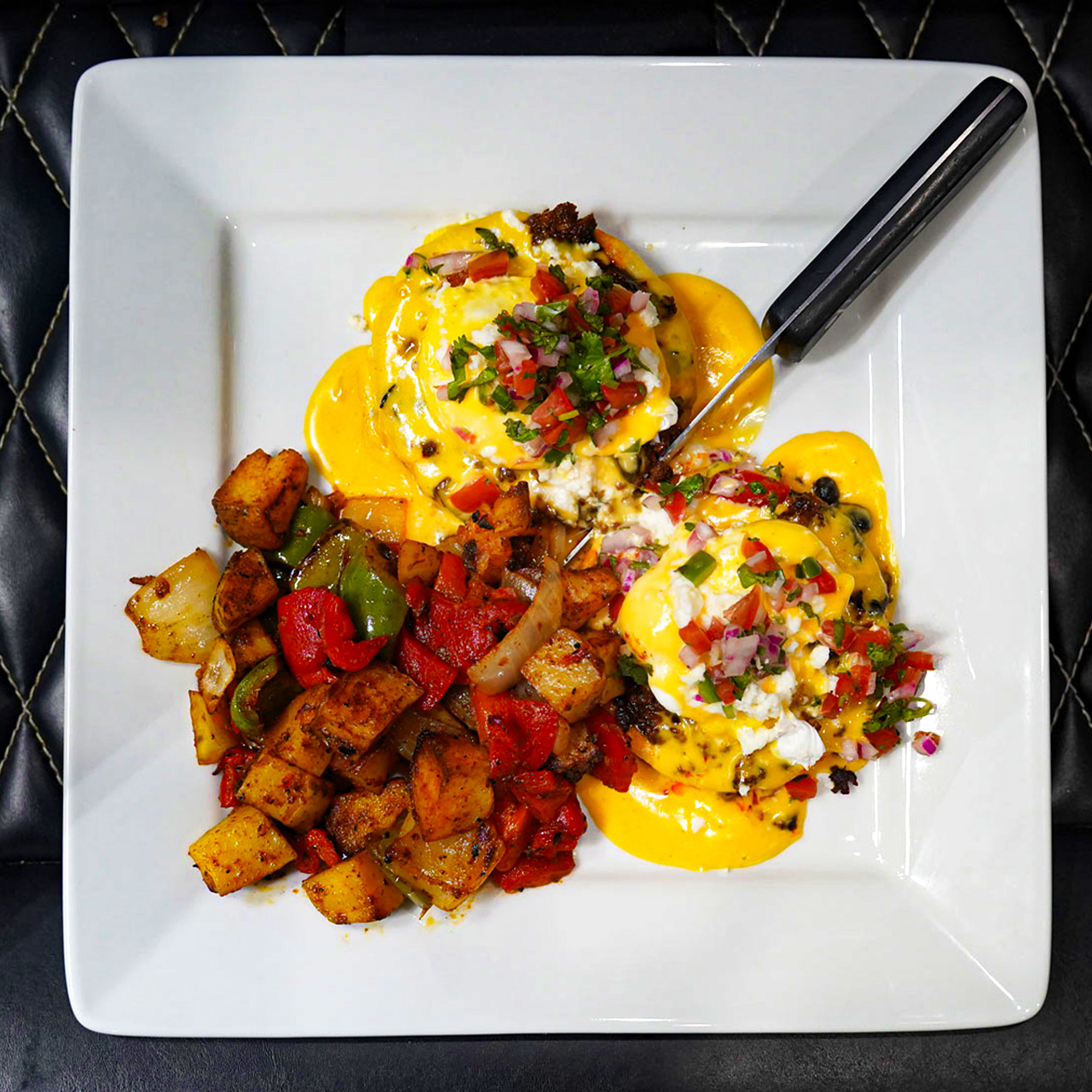 Chorizo, black beans & poached eggs on crispy sopes shells topped with chipotle hollandaise, queso fresco and pico de gallo. Chorizo, black beans & poached eggs on crispy sopes shells topped with chipotle hollandaise, queso fresco and pico de gallo.