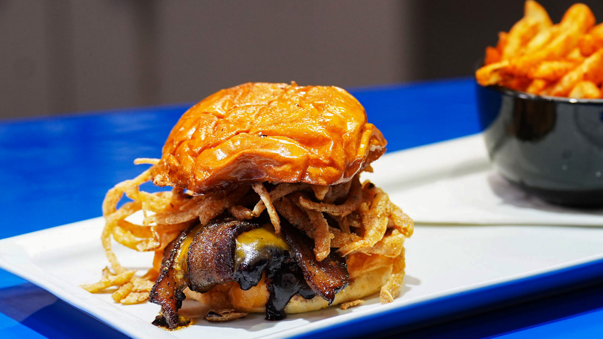 Grilled chicken breast, topped with berry BBQ sauce pepper candied bacon, truffled onion strings, and sharp cheddar