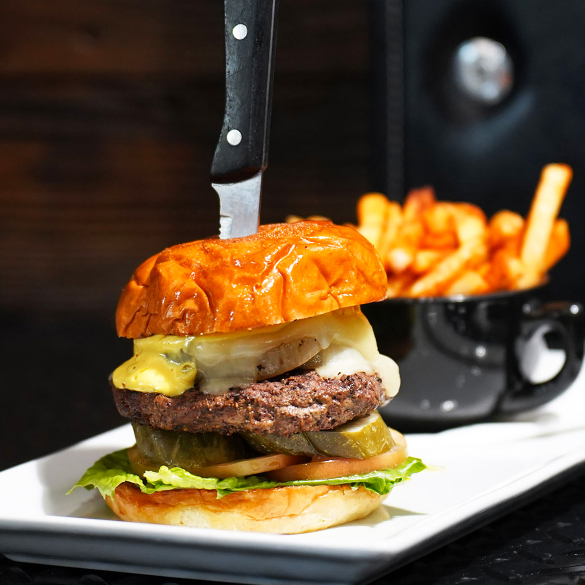 Premium smash patty topped with jack cheese, steamed onions, romaine hearts, tomato, pickle, and house spread