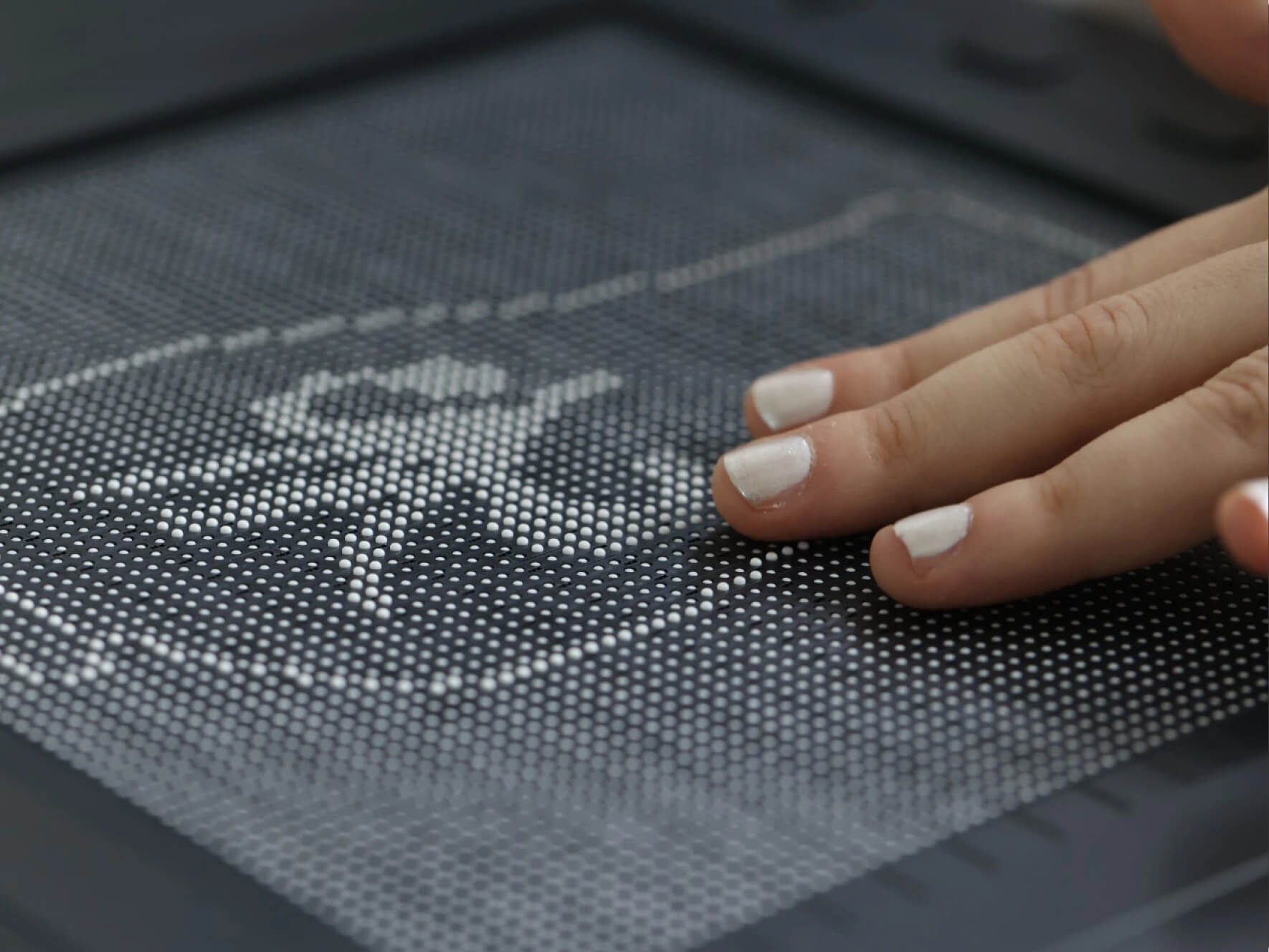 Woman's hand interacting with the Dot Pad.